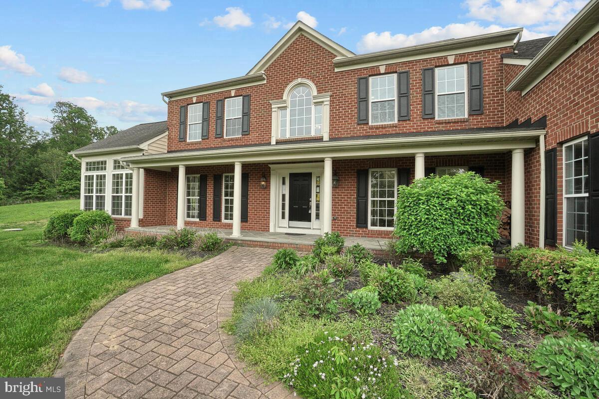 JUST REDUCED!! Owners relocating - their loss is your gain. Your dream home awaits! This home boosts a commuter friendly location to Washington DC or Baltimore, MD in one of Howard County's most highly sought after school districts. Brick front, scenic setting, and an inviting slate covered front porch await! Grand two-story foyer embellished with an intricate dual staircase and a stone accent wall, imposing formal living and dining room, solarium, large Butler's pantry, and a welcoming family room adorned with a stone profile wood burning fireplace encompass the main floor. Top of the line granite countertops in the kitchen and all bathrooms, hardwood floors on the main and upper level! Many upgrades too numerous to list. The kitchen highlights include custom cabinetry, accent center- Island, prep sink, double gas stove, breakfast room, and an adjoining sunroom. Spacious owner's suite boasts a tray ceiling, sitting room, architectural columns, sitting room, and two walk-in closets. Five vastly sized bedrooms with walk-in closets, dual entry bath, and ensuite bathrooms conclude the upper level. The lower level boasts a beautiful stone wet bar, additional BONUS room, full bath, and theatre/music room. Three-car garage with side access to the home. A expansive deck overlooks an amazing view of the property situated on 3 scenic acres. OPEN HOUSE - September 22nd from 1-3pm