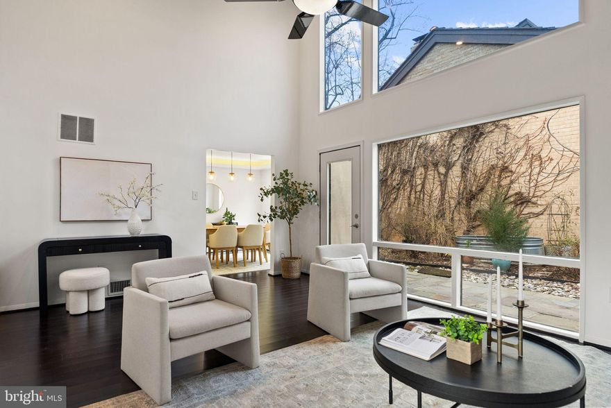 Nestled on a quiet, leafy cul-de-sac in one of Bethesda’s most sought-after enclaves, 6305 Contention Ct is a masterclass in light, scale, and sophisticated design. The journey begins in the grand foyer, where soaring ceilings transition into a breathtaking living room featuring dramatic vaulted ceilings and floor-to-ceiling windows that bathe the space in natural light. For formal gatherings, the dining area exudes refined elegance, highlighted by custom crown molding with integrated ambient uplighting. This sense of architectural grandeur continues into the incredible gourmet kitchen, a chef’s masterpiece featuring upgraded granite countertops and an abundance of custom cabinetry. The space remains sleek and uncluttered thanks to integrated professional appliances, including a refrigerator designed to blend perfectly with the cabinetry for a seamless look. The heart of the home flows naturally into a warm, inviting family room anchored by a cozy gas fireplace, perfect for relaxed evenings.
The primary suite is a true architectural showstopper and a private sanctuary within the home. Beneath lofty vaulted ceilings, you’ll find a private gas fireplace and a unique spiral staircase leading to a secluded loft area, an ideal space for a home office, library, or yoga retreat. The primary bath offers a resort-at-home experience, boasting an oversized jetted soaking tub, a massive separate shower, and a generous walk-in closet. The additional bedrooms are equally impressive, providing ample space and comfort, while the home even features a private sauna for ultimate wellness. Outside, the residence is framed by elegant professional landscaping, and the large 2-3 car garage is ready for the future with a universal electric car charger. Perfectly positioned for the modern professional, you are just minutes from NIH, Walter Reed, and major DC commuter routes, with the world-class dining and boutiques of both Downtown Bethesda and Rockville only moments away. Welcome home!