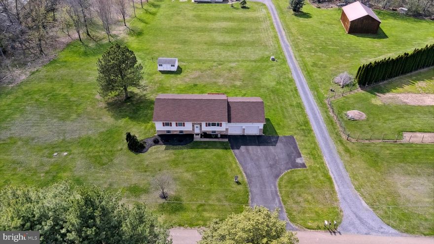 Proudly offered by the original owners!  This lovingly maintained  custom built 4-bedroom, 3-bathroom split-level on a beautiful 1 acre lot, offers the perfect blend of comfort, space, and serenity!  

The upper level features a spacious primary bedroom with an en-suite bathroom, two additional bedrooms, and another full bathroom.   The warm and inviting country kitchen, complete with a sliding door to the deck, seamlessly flows into the adjoining living room, creating an ideal space for gatherings.

The lower level includes a generous living area, a large bedroom with a walk-in closet, a full bathroom, a versatile bonus room, and a private rear entrance. This level offers endless possibilities—perfect as an in-law suite, guest quarters, or for multi-generational living.

Additional highlights include an oversized garage with built-in storage shelves and a recently installed roof, providing peace of mind for years to come! Put this one on your tour!