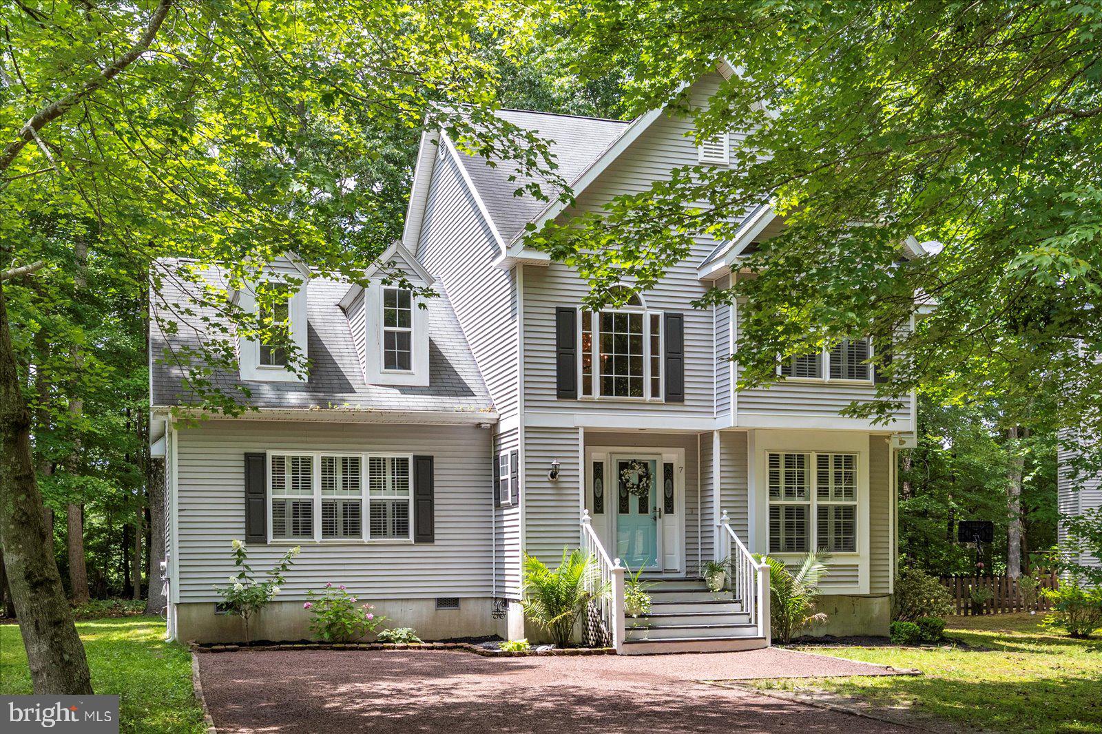 PRICE REDUCTION!!! Tucked away on a quiet cul-de-sac and set on one of the largest lots in Ocean Pines, this beautifully maintained 4-bedroom, 2.5-bath home offers 2,200 square feet of comfort, style, and privacy—with a serene backdrop for added tranquility.
Inside, you'll find an updated kitchen with modern finishes that include quartz countertops, finger print resistant slate appliances and ample cabinetry, flowing seamlessly into the main living areas. Just off the main space, an attached all-season room provides the perfect spot to relax, unwind, or entertain year-round.
Step outside to enjoy the expansive back deck and patio—an ideal setup for summer gatherings, peaceful mornings, or evenings under the stars—all framed by your generous and private backyard.
The spacious primary suite offers a true retreat with dual walk-in closets and a beautifully custom tiled bath, marble vanity top and walk in shower. Upstairs, three additional bedrooms and a full bath provide plenty of space for family, guests, or a home office setup.
With its quiet location, oversized lot, and well-appointed features, this home is a rare find offering the perfect blend of space, style, and setting.