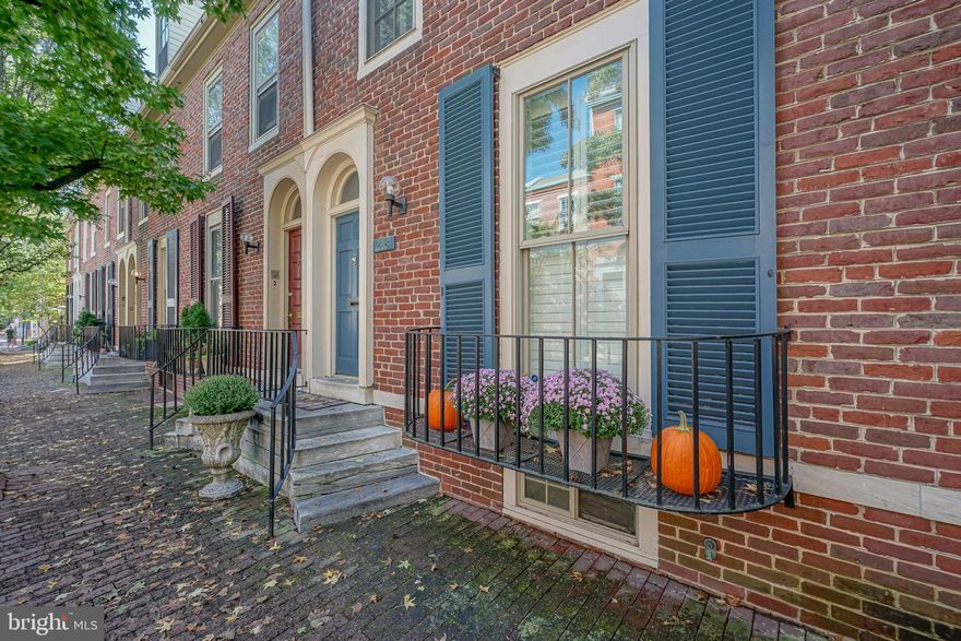 Welcome to 218 Pine Street, an elegant townhome located on a picturesque, tree-lined street in the heart of Society Hill. This home is part of Philadelphia’s Blackwell Place granting you exclusive access to an immaculately maintained, large landscaped courtyard that is directly behind your own private and gated patio. Upon entering the home, take notice of the high ceilings and beautiful hardwood flooring which continues throughout. The first floor features a dining room with quaint street views from an oversized front window. Adjacent to this space is an updated chef's kitchen featuring stainless steel appliances, custom cabinetry, a double-door built in pantry, granite countertops and a mosaic tiled backsplash. There is a conveniently located half bath down the hallway. Follow back to the grand living room, complete with south facing, floor to ceiling windows with French doors leading to a private red brick patio and a gate which opens to the courtyard of the close knit Blackwell Place community. This courtyard is truly like having the suburbs in the city without any of the associated work. Heading up to the second level you’ll find a guest room that looks out onto Pine Street and features an en-suite bathroom and 2 built-in Murphy bunk beds, a space saving design making this a great option for a home office or workout room. Down the hall is the spacious primary suite featuring two double-door closets and a pair of oversized, south-facing windows which look out over the courtyard and cherry trees. The en-suite bathroom features a custom wood vanity and a floor to ceiling glass shower with a rainfall showerhead. The third floor boasts two additional bedrooms with built-in custom shelving for convenient storage and an additional updated full bathroom with a double vanity. A fully finished basement provides an additional living space that can be used as a family/TV room, with a convenient powder room as well as a dedicated laundry and storage rooms. The Seller is also offering one year prepaid garage parking, located directly across the courtyard at 2nd and Lombard. This home perfectly blends all the conveniences of modern-living with old Philadelphia charm in one of the most walkable and enjoyable neighborhoods the city has to offer. Make sure to walk down to Headhouse Square and enjoy the farmer’s market during the day and one of the many local restaurants in the evening. The incredibly low HOA fees of $1100 per year cover the maintenance and land taxes of the courtyard.