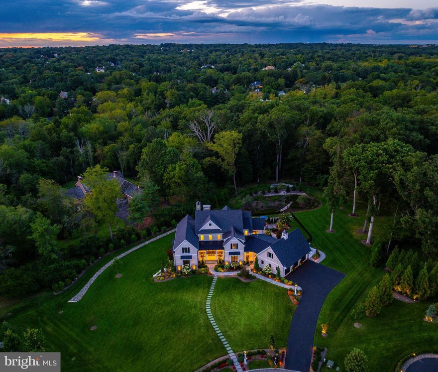 Why travel when home feels like a five-star resort? Welcome to this nearly new 7,000 sq ft custom residence tucked at the end of a quiet Gwynedd Valley cul-de-sac of just seven homes—where everyday living feels like a year-round getaway.
This elegant home has been designed for comfort, convenience and entertaining. The main level offers : a first-floor owner’s suite with vaulted ceilings and sitting area, a spa-worthy bath with heated tile floors, soaking tub, dual vanities, make-up station, and a custom walk-in closet..
Entertaining is effortless with four kitchen areas and three fireplaces. The main kitchen features Wolf, SubZero, and Bosch appliances, quartzite countertops, banquette seating, a coffee bar, and adjoining back kitchen with farmhouse sink, refrigerator, additional dishwasher and pantry for seamless prep. A chic mini-bar with SubZero wine fridge completes the space. Step outside through twin 12’ glass sliders to a covered terrace with skylights, outdoor fireplace and TV, Lynx-equipped kitchen, and expansive dining and seating areas. The heated saltwater pool and spa, expansive decking and with a grotto fire pit—it’s an entertainer’s dream. The fully finished walk-out lower level adds an additional full kitchen, SubZero-equipped bar, gym, full bath, dual-sided fireplace, and recreation areas, in addition to a 12’ slider that leads to a covered patio and the pool area.
Upstairs, a retreat-style loft lounge with bar, three bedrooms (all with custom closets and ensuite or Jack-and-Jill baths), plus a third-floor bonus room, creates flexible living for guests, family, or work-from-home needs.
A 3-stop elevator ensures easy access to all levels, making this a forever home. Every detail has been fortified for peace of mind: whole-house generator, Lutron lighting system, Honeywell security, Luma cameras, Sonos sound inside and out, central vacuum (including garage), three HVAC systems across five zones, two Navien tankless water heaters, a water softener and integrated cabling/Wi-Fi throughout. Car enthusiasts will love the three-car garage with epoxy floors, slat walls, custom cabinetry, and a 240-volt line for an EV charger.
Set on 1.68 private acres that back up to wooded lands, the property offers lush landscaping with irrigation and lighting, and expansive outdoor living spaces. Proximity to the Gwynedd Valley train station, Wissahickon Trails, and Lower Gwynedd’s scenic walking paths complete the picture.
This is not just a home—it can also be your luxury staycation home.  Call for your showing TODAY!