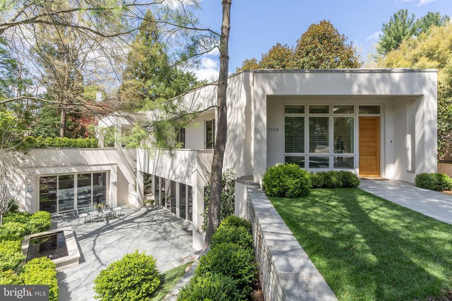 Hidden jewel on one of Washington’s most sought-after streets in the desirable Kent neighborhood. Tucked away at the end of a long private drive, you’ll find this secret retreat nestled among mature trees featuring the beauty of indoor-outdoor living. This stylish contemporary is a nature lover’s dream. Both the living room and den open to a private courtyard perfect for entertaining while each of the bedrooms has its own access to a terrace or balcony.  The home's clean-lined contemporary design features an open floor plan, high ceilings and walls of full-length windows that capture natural light and beautiful leafy, green views from all angles. Wide, dramatic staircases flank either side of the home providing wonderful flow, and its gallery walls are perfect for displaying artwork. Ideally situated across from Battery Kemble Park’s trails and minutes to Palisades’ restaurants, shops and farmer’s market. Experience city living in a natural setting with quick and easy access to downtown Washington, Reagan National Airport, and I-495. An elevator, abundant storage and a 2-car garage with additional driveway parking add to this meticulously maintained property. Its architectural detail and magical setting make it a home like no other.