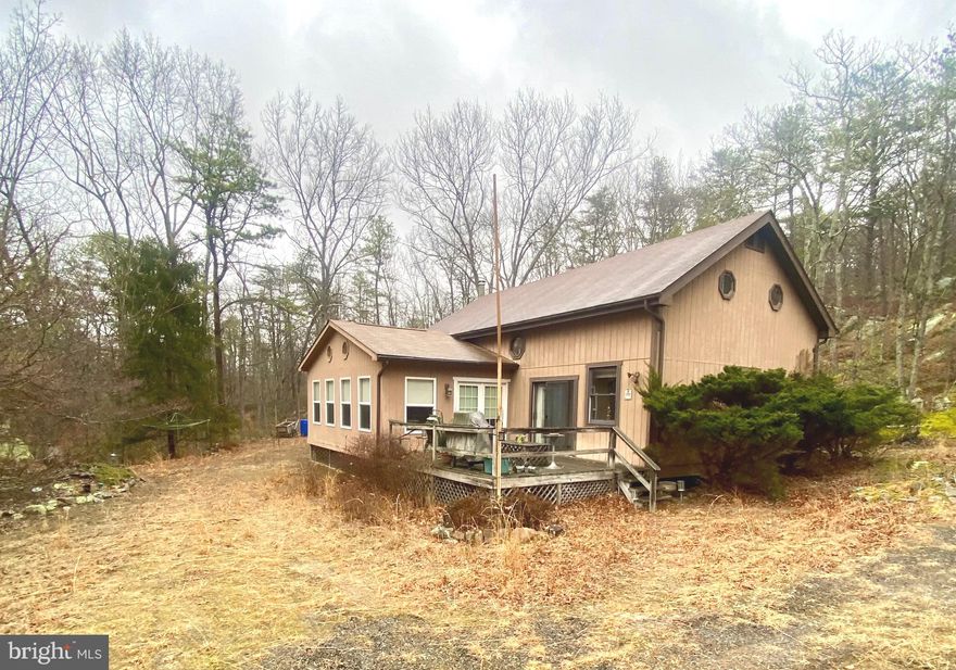 This is your chance to own your own cabin in wild, wonderful West Virginia!!!  This home is secluded and private but close to all the amenities the community offers.  Inside you will find a modern kitchen with an island, a huge family room, and a dining area.  There is also a large sun room with lots of windows, and a main floor bedroom and full bath.  Outside there is a deck perfect for a hot tub,  two large outbuildings, and a flat yard.  There is also an over-sized garage/workshop! The community offers a stocked fishing lake, a beautiful swimming lake with sand, tennis courts, a park for the kids and 18 plus miles of roads to ride your ATV.  This house would work as a full time residence, a weekend get away or an Airbnb.  Don't miss this one!