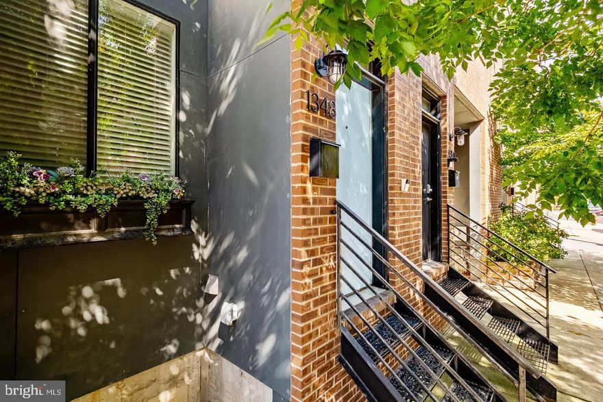 Welcome to 1348 Mascher Street, offering 2 car parking spaces (one garage space and one dedicated off-street parking pad), nearly 2,800 sq ft of thoughtfully designed living space, 3 bedrooms, 2.5 baths, three outdoor spaces, and a massive, finished basement — all in the heart of vibrant Fishtown. Step inside this 17-foot-wide townhouse boasting a completely open layout featuring a spacious living area, dining room, and a sleek, modern kitchen outfitted with Quartz countertops and stainless-steel GE appliances. PERFECT for entertaining! On the second floor, you’ll find a flexible open space ideal for a home office, den, or playroom, which opens onto a private patio — perfect for grilling or relaxing outdoors. Across the hall, the primary suite awaits, complete with a walk-in closet, private balcony, and a spa-like en-suite bathroom featuring a double vanity and frameless glass shower. The third floor offers two additional spacious bedrooms, a full bathroom, and a dedicated laundry room. Top it all off with a private 700+ sq ft rooftop deck, boasting unparalleled views of the Philadelphia skyline and the Ben Franklin Bridge. Head downstairs to the fully finished basement — the perfect spot for a second living room, playroom, home theater, gym or all of the above. This level also includes a convenient half bath and a custom original mural by renowned Fishtown graffiti artist Gloss Black. And the location? Simply unbeatable. Steps from award-winning restaurants like Suraya and Laser Wolf, local favorites include Evil Genius, Wm Mulherin's & Sons, Philadelphia Cider Works, and just around the corner from the newly renovated Hancock Playground. Plus, easy access to I-95 and the Girard stop on the Market-Frankford Line makes commuting a breeze. Do not wait — this one has it all and won’t last long!