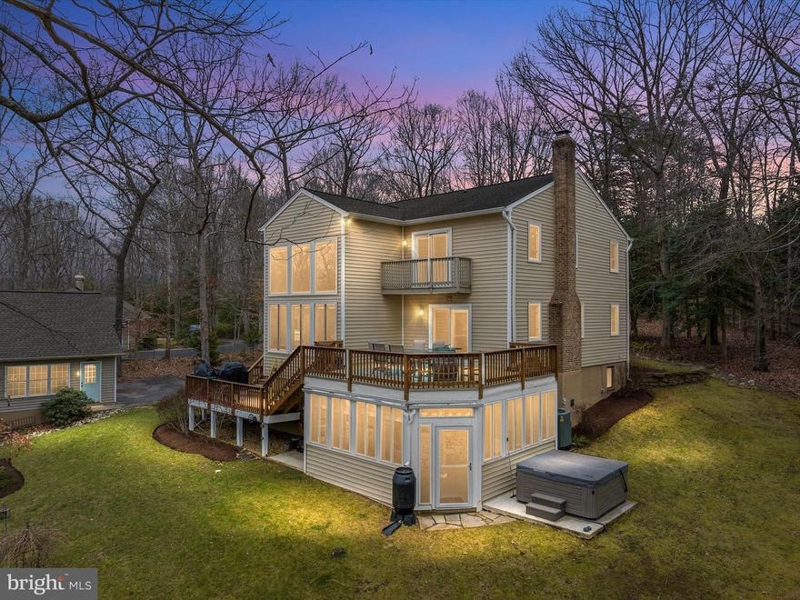 Discover serenity in this spacious, nature-inspired home situated on an acre and a half in the enchanting neighborhood of North River Forest. The kitchen is truly the heart of this home, featuring a prep island, a peninsula for gathering and serving, and custom maple cabinetry - all perfectly complemented by a slate backsplash and sparkling granite countertops. Descend into the breakfast room, where soaring ceilings and two-story windows create a bright and airy space. The large family room is enhanced by the cozy ambiance of a wood burning fireplace and opens to a rear deck overlooking picturesque views of nature’s bounty. Designed for comfort and versatility, the main level features a flexible study or main level bedroom. 

Skylights illuminate the stairwell with natural light.  At the top of the stairs, you’ll find a window seat, offering a cozy spot to relax while enjoying scenic views of the front yard.  The primary suite is generously sized with luxe details such as a private balcony, two walk-in cedar closets, and an attached loft. The ensuite bath is sleek and luxurious, with exotic cabinetry, a soaking tub, spa-like shower with body sprays, and gorgeous tilework. Convenience meets functionality in the upper-level laundry room, offering base and wall cabinetry, countertops for folding, and a sink.

Host the most amazing parties in the expansive lower-level rec room, complete with a built-in wet bar. Walkout to the three-season porch or step outside to unwind in the hot tub, where you'll fully appreciate the tranquility of your surroundings.  Multiple decks span the rear of the home overlooking a park-like setting. The detached two-car garage features a studio with a powder room, offering a personal retreat for creativity or leisure.  Imagine hiking through woods to reach water’s edge, or gathering around the firepit, chilling in the hammock, or simply decompressing to the soothing sounds and scenery.  Private, yet inviting, this home is like no other.  Just minutes from History Downtown Annapolis, commuter routes, and the water.  COME FOR THE EXPERIENCE, STAY FOR THE LIFESTYLE!