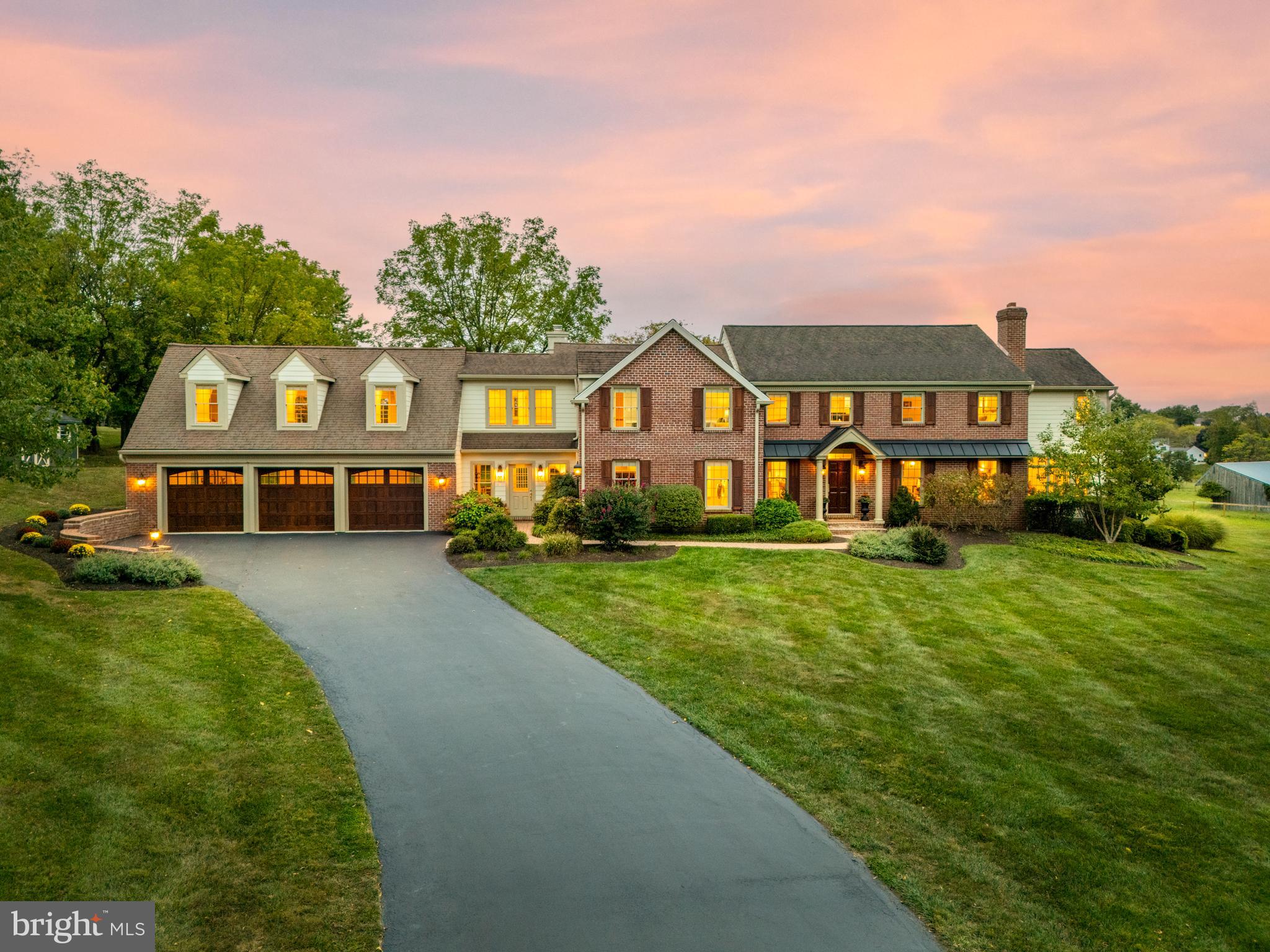 Welcome to 210 Line Rd, where classic charm meets quiet luxury in a 5,200 sq. ft. brick and plank colonial. Nestled on a tranquil 2-acre lot, this home offers an idyllic retreat with scenic views from every window, spacious rooms, and thoughtful upgrades for today’s lifestyle. Step inside to discover gleaming hardwood floors and freshly painted neutral walls throughout the main level, which seamlessly connect the formal and casual spaces, and continue onto the 2nd level. The formal entryway graciously welcomes guests to the home and leads into the sunlit space beyond. The renovated kitchen, completed in 2023, is a chef's dream with neutral cabinetry, quartzite countertops, large island and top of the line stainless steel appliances. The open-concept layout flows into the inviting family room with a stone fireplace, perfect for cozy evenings at home or casual gatherings. Imagine meals with friends, watching a game on tv or playing games by the fire while enjoying views of the picturesque backyard and conserved open space beyond. The formal living room, adorned with its own granite fireplace, sets the stage for elegant entertaining, while the formal dining room is ideal for hosting special dinners or holidays. Natural light floods the adjoining sunroom, offering a peaceful spot to sip your morning coffee, read, converse and gaze out to the beautiful and colorful landscape beyond. Step out to the balcony where you can observe a friendly game of tennis or basketball on the lighted sport court! The first-floor laundry room, walk-in coat closet, custom cubbies and large tiled mudroom off the 3 car garage ensure convenience, an abundance of storage and functionality for daily living. As you head upstairs, the spacious landing area features a built-in desk, providing a cozy nook for working from home or a study area. The primary suite is a sanctuary, with vaulted ceilings, wood beams, and a dressing area with his-and-hers walk-in closets and vanity. Wake up each morning to serene views of your backyard, and unwind in the en-suite bath. Two additional bedrooms share a hallway bath, while the fourth bedroom has its own private bath across the hall. At the end of the hall, a large bonus room serves as a perfect hangout space, second family room, or playroom—complete with a mini fridge and cabinetry. Picture movie nights, game days, or simply relaxing in this inviting space. The finished lower level offers endless possibilities for recreation and relaxation. A mini kitchen makes it perfect for entertaining, while the bonus room, potentially a gym or office space, can be tailored to your personal needs. The 4th full bath is located on this level. Walkout to the backyard from the bonus room to enjoy the outdoor features of this home. Picture spending weekends lounging on the hardscape patio taking in the peaceful views and changing seasons, hosting gatherings on the covered bluestone patio, enjoying a tennis match on your own lighted court and watching the sun set over the fields. Located just minutes from the charming downtowns of Malvern and West Chester, beautiful East Goshen Park, country clubs, Radnor Hunt and renowned public and private schools, this home offers the perfect balance of quiet living and convenience. Enjoy easy access to shopping, dining, outdoor recreation and transportation while still feeling like you’re miles away from it all surrounded by horse farms and stables, historic properties, preserves and rolling hills. This stunning property provides not just a home, but a lifestyle—where luxury, comfort, accessibility and scenic beauty come together.