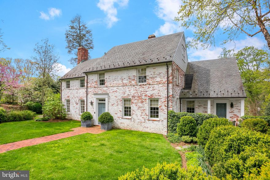 This elegant, beautifully renovated Georgian Colonial estate is discreetly sited on a serene private street in the highly desirable Kent neighborhood. Perfectly situated across from Battery Kemble Park on an acre of extensively landscaped gardens and grounds, this residence offers a remarkable in-town opportunity to escape the bustle of the city. Built in 1936 for Eleanor Dulles, sister of John Foster Dulles, the original farm house was designed by legendary, pioneer woman architect Gertrude Sawyer with a later addition by notable architect, Anne McCutcheon Lewis. Since then, and more recently, the property has been meticulously renovated and expanded again to include nearly 8,000 square feet of living space and extraordinary gardens and outdoor entertaining and living spaces. No detail was overlooked in the exceptional transformation of this historic residence, with masterful collaboration from Solis Betancourt and Sherrill (interior), Barnes Vanze (architect), and Richard Arentz (landscaping). Design features such as bead board, recessed lighting, heart pine floors, moldings, unlacquered brass hardware, and bluestone are found throughout the interior and exterior of residence.  The stunning grounds and gardens of the residence designed by Richard Arentz are unparalleled. With this rare offering of over an acre of land (one of only 3 properties currently listed in Washington with more than an acre), the exterior is exceptionally private and wonderful for entertaining, offering multiple seating/al fresco dining areas with outdoor music speakers, extensive landscaping, numerous fruit trees, a perineal garden, several honeybee hives, a vegetable garden, basketball court, and an impressive 50’ pool surrounded by a bluestone sundeck. This exceptional and rarely available offering provides the elegance and peace of country living without sacrificing modern comfort and convenience. Extensive and elegant accent and other lighting has been placed around the entire property for evening entertaining ambiance. Upon entry into the home, a welcoming foyer provides transition to the formal rooms on the main level. The formal living room with a beautiful antique mantel and a large fireplace and is directly opposite the elegant dining room. The modernized farmhouse kitchen is well-appointed with Vermont Slate and zinc countertops, a large center island, two dishwashers, two ovens and sinks, a wine refrigerator, and abundant cabinetry storage. The kitchen overlooks the beautiful rear gardens and accesses a large pantry, mudroom, and adjacent dining/breakfast room. The expansive family room is wrapped in glass windows and offers an impressive fireplace with a stunning antique mantle. The room is a haven of entertainment, featuring a concealed drop-down 11’ wide movie/TV screen, a projector, dramatic surround sound, and Lutron blackout shades, providing an immersive cinematic experience, perfect for movie night or watching sporting events. This level provides access to multiple separate terraces, creating a wonderful flow for entertaining and seamlessly blending indoor and outdoor spaces. There is also a piano room, powder room, and two coat closets on the main floor.  The second level of the residence offers four bedrooms and three full bathrooms, including the luxurious primary suite. The primary bedroom has a dramatic Western facing window overlooking the garden, multiple walk-in closets, blackout shades, and an en-suite bathroom with dual vanities, a steam shower, and separate soaking tub. The primary bedroom also provides private access to the third floor, which offers an exercise room, office, and oversized cedar closet. There are three additional bedrooms and two bathrooms on the second level, which share a central homework room/library with built-ins. All of the bedrooms on this floor are spacious, light-filled, have generous closet space, and a laundry chute that leads down to the lower level laundry room.