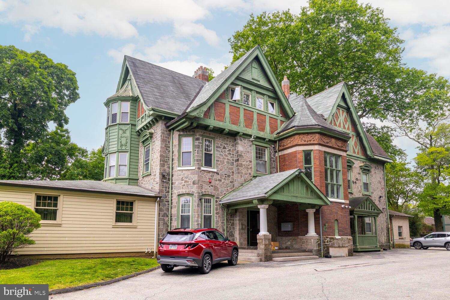 Discover the timeless charm and modern versatility of 143 Walnut Lane, a rare, turn-key mixed-use asset nestled in the heart of Philadelphia’s Tulpehocken Historic District. This impeccably maintained 20-unit property offers a unique blend of classic architecture and contemporary appeal, making it an exceptional addition to any investment portfolio.At the forefront is a graciously restored Victorian mansion, housing five spacious residential apartments that showcase exquisite historic details while offering modern comfort. Just behind it, a 14-unit commercial building—complete with a bonus residential apartment—delivers steady income and flexible use potential, ideal for creative, professional, or medical tenants.Both structures are supported by a large off-street parking lot and surrounded by a serene common garden, offering tenants a rare combination of convenience and tranquility. The location is equally compelling: just two blocks from the train station and four blocks from the scenic trails of Wissahickon Park, this property provides seamless access to Center City while maintaining a peaceful, community-oriented vibe.Whether you're an investor looking for a low-maintenance, income-producing asset or a buyer drawn to the historical significance and strong tenant appeal, 143 Walnut Lane is a truly exceptional offering in one of Philadelphia’s most picturesque and well-connected neighborhoods.