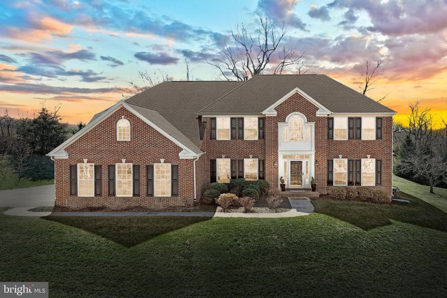 Welcome to a refined residence where classic elegance meets modern convenience. Enter through a two-story grand foyer featuring gleaming hardwood floors and a sweeping staircase that leads to an open, light-filled layout. To the right, a cozy sitting room with a bay window awaits, while to the left, a formal dining room with a tray ceiling sets the stage for both casual & formal gatherings. A butler’s pantry opens into a gourmet kitchen complete with an island, stainless steel appliances, a gas cooktop, wood cabinetry, polished granite countertops, and a walk-in pantry—complemented by an adjoining sunroom. The two-story great room, centered around a striking stone gas fireplace, seamlessly connects to a corner office with vaulted ceilings and French doors. This office flows directly into the first-floor bedroom space, which is uniquely connected to an adjacent full bath—ensuring a seamless, one-level living arrangement ideal for guests or in-laws. The entire home is fully wired with integrated speakers for an immersive audio experience throughout. ***Upstairs, the luxurious primary suite features its own sitting room, two generous walk-in closets, and an en suite bathroom with a soaking tub, separate shower, double vanities, and a private water closet. Additional bedrooms are thoughtfully appointed with private or shared baths, a convenient laundry chute, and ample linen storage.***The lower level offers a welcoming gas fireplace, walk-out access and natural light, creating a versatile space for everyday living, media, fitness and entertainment options. This expansive area includes the 5th full bathroom, ensuring convenience along with a large unfinished storage area to house your belongings and seasonal items with ease. ***Outside, a charming patio invites you to relax in a serene setting. Blooming roses, cheerful daisies, and other natural beauties enhance the property. The owner's meticulous care and attention to details make this home as inviting as it is impressive. Located in a quiet, picturesque area just minutes from Route 30, this home offers easy access to dining, shopping, and country club amenities. Discover a home that blends traditional elegance with modern convenience—offering flexible spaces and luxurious details to accommodate every chapter of life!