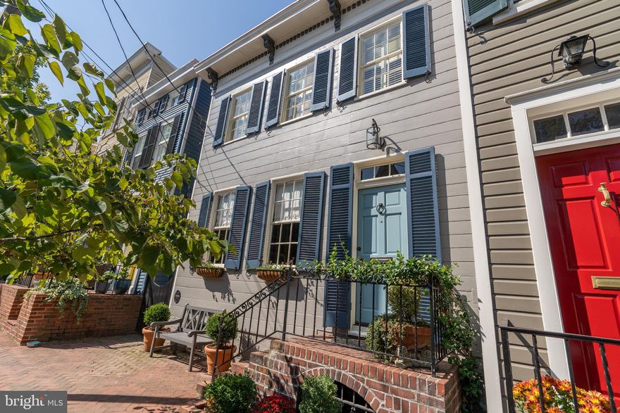 Don't miss this unique opportunity to own a historic gem on one of the most charming, picturesque streets in Old Town, Alexandria. Built in 1800, this home has benefited from thoughtful updates, while continuing to showcase its historic character. You are welcomed with charming curb appeal featuring a newly installed brick herringbone sidewalk.  Entering the home, you pass through an elegant foyer that has been enhanced with a conveniently located coat closet, on your way into the beautiful living room with built-in bookcases, a gas fireplace and wood floors. The formal dining room offers additional built-ins and a fireplace.  A beautifully updated kitchen features a center island, gas range, wine refrigerator and abundant cabinet storage.  Adjoining the kitchen is a family room with a wood-burning fireplace and direct access to an enchanting patio and garden with alley access.  The upper level boasts three spacious bedrooms and two spectacularly renovated baths, one with a soaking tub and the other with a steam shower feature.  You will find the full-size laundry and additional room for storage on the lower level. This semi-detached townhome is flooded with natural light and is offered in pristine, move-in condition. Located just steps from the Mt. Vernon Trail, the Potomac River, shops and restaurants on King Street, and easy access to National Airport, Metro, Amazon HQ2, and major commuter routes.