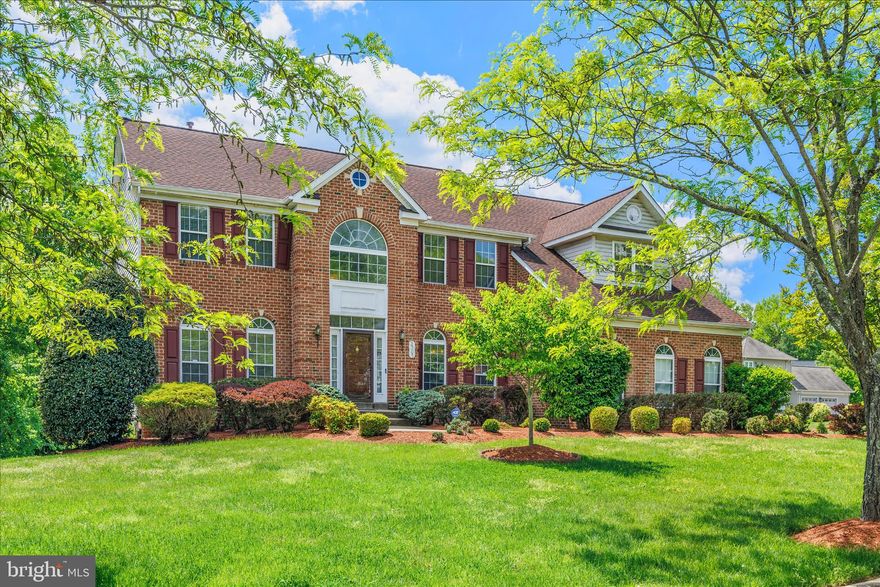Elegant Brick Colonial Estate on a private One-Acre Lot in Bowie! View the Interactive Floorplan and discover over 5,500 square feet of refined living in this beautifully updated 5-bedroom, 4.5-bath Colonial, ideally set on a serene One-Acre lot in Bowie's prestigious Woodmore Highlands community. A grand two-story foyer and rich hardwood floors introduce a light-filled, open layout designed for both everyday living and upscale entertaining. The Gourmet Kitchen impresses with beautiful granite countertops, an oversized island with gas cooktop, premium stainless steel appliances including double ovens, custom pantry, and a thoughtfully designed workspace. The kitchen creates a warm gathering place with its seamless flow into the sunlit Breakfast Area and dramatic Family Room anchored by a striking wood-burning fireplace. Custom French doors lead to an expansive deck overlooking the private, level backyard—perfect for outdoor gatherings. Upstairs is a sanctuary of comfort featuring 4 generously proportioned Bedrooms and 3 full Baths. The luxurious primary suite features a walk-in closet and spa-inspired bath showcasing dual vanities, a deep soaking tub, and a separate glass-enclosed shower. A second bedroom with private en-suite full bath offers ideal guest accommodations. Two more generous bedrooms share the additional double-vanity full bath upstairs. Downstairs, the fully-finished walkout basement is designed for versatility and includes an expansive Recreation Room, fifth bedroom, bonus room, and fourth full bath—perfect for extended living or entertaining. The basement also has direct French doors access to the backyard. This distinguished home has been meticulously maintained and thoughtfully updated with recent upgrades ensuring both comfort and peace of mind for the discerning buyer: Roof 2021, HVAC and furnace 2022, basement carpet 2024, update powder room and laundry room 2024, grab bars in primary bathroom and powder room 2025, security system 2020, and in-ground sprinkler system on front lawn). Schedule your private showing appointment today (one hour advance notice required). See why Bowie has earned a spot on the list of the 10 Best Places to Live in Maryland for 2026, standing out for its strong balance of affordability, job access, healthcare, and everyday convenience. Sale is contingent on seller finding home of choice.