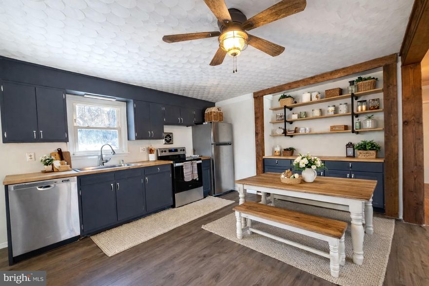 Start the New Year as a homeowner in this charming country rancher. Set on just under an acre, this 3-bedroom, 1-bath home offers a peaceful setting with wooded views and plenty of space to enjoy the outdoors.

Inside, you’ll find an open layout that works well for everyday living. The kitchen has been lightly updated with stainless steel appliances and butcher block countertops, and it opens nicely into the main living area - great for hosting friends or enjoying quiet evenings at home. Hardwood floors in the bedrooms, updated light fixtures, and ceiling fans throughout add comfort and character.

Outside is where this property really shines. The nearly one-acre lot gives you room to relax, garden, or simply enjoy the surrounding woods. A wood stove adds warmth and charm during colder months, and a newer water heater provides added peace of mind.

The open, unfinished basement offers plenty of potential—whether you’re thinking about extra living space, a workshop, a home gym, or additional storage. An attached one-car carport adds everyday convenience.

Virtual staging photos are included to help show the home’s potential and give you an idea of how the space could look once furnished. Furniture and décor are not included.

While the home could benefit from a little TLC, it is move-in ready and full of opportunity - ideal for first-time buyers, downsizers, or anyone looking for a quiet country setting.

Schedule your showing today and come see what this home has to offer.