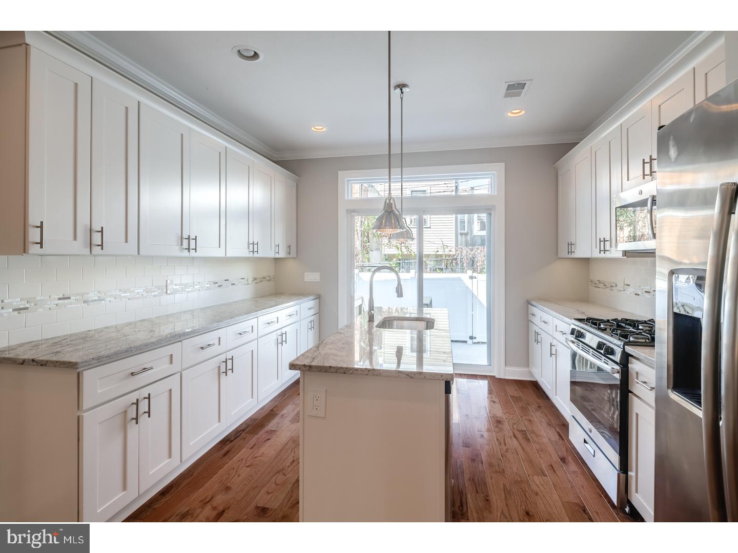 HUGE new construction home w/amazing layout and tons of natural light. This 2350sq' + /- home built by V2 Properties has it all. 2-zones of heating and air, approved 10- Year Tax Abatement, 3 bedrooms, 3 baths, a ROOFDECK, and large rear yard. The amazing granite kitchen has luxury cabinets, tiled backsplash and pendent lighting over the island. Hardwood floors throughout and the technology package is included. Full 3rd floor master suite has walk in closets, accent mood lighting, a Trey ceiling with crown molding, a Spa inspired bathroom with double vanity and glass shower and a wet bar leading up to the full roofdeck... The two additional bedrooms are a great size and have large closets and bright natural light. The 2nd floor full bathroom also has a double vanity.The large rear yard is perfect for the BBQ and entertaining. the finished lower lever has a tile floor and full bath and can be a 2nd living room or 4th bedroom. Custom finishes everywhere! hardwood floors, designer tile, iron railing systems, speakers built into the ceiling and walls, video doorbell and more!! Roofdeck has a very durable fiberglass decking and parapet walls for privacy. The front facade is brick with a designer standing seam metal sided bay and iron railing. All of the bath vanity counter-tops are granite or quartz. Top quality HUGE New Construction Home at a very reasonable price, built by the city's premier home builder and backed by the best home warranty in the business.