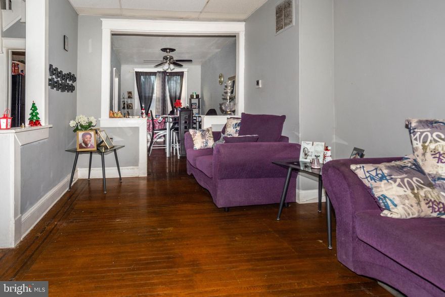 TURN KEY ROWHOME WITH 3 FINISHED LEVELS AND OFF STREET PARKING!  Features include an enclosed porch,  hardwood floors throughout, main level with a spacious living room, separate dining room, and kitchen, upper level with 3 bedrooms and 1 full bath, fully finished basement with a family room and half bath, small rear patio, and oversized parking pad!  Tenant occupied