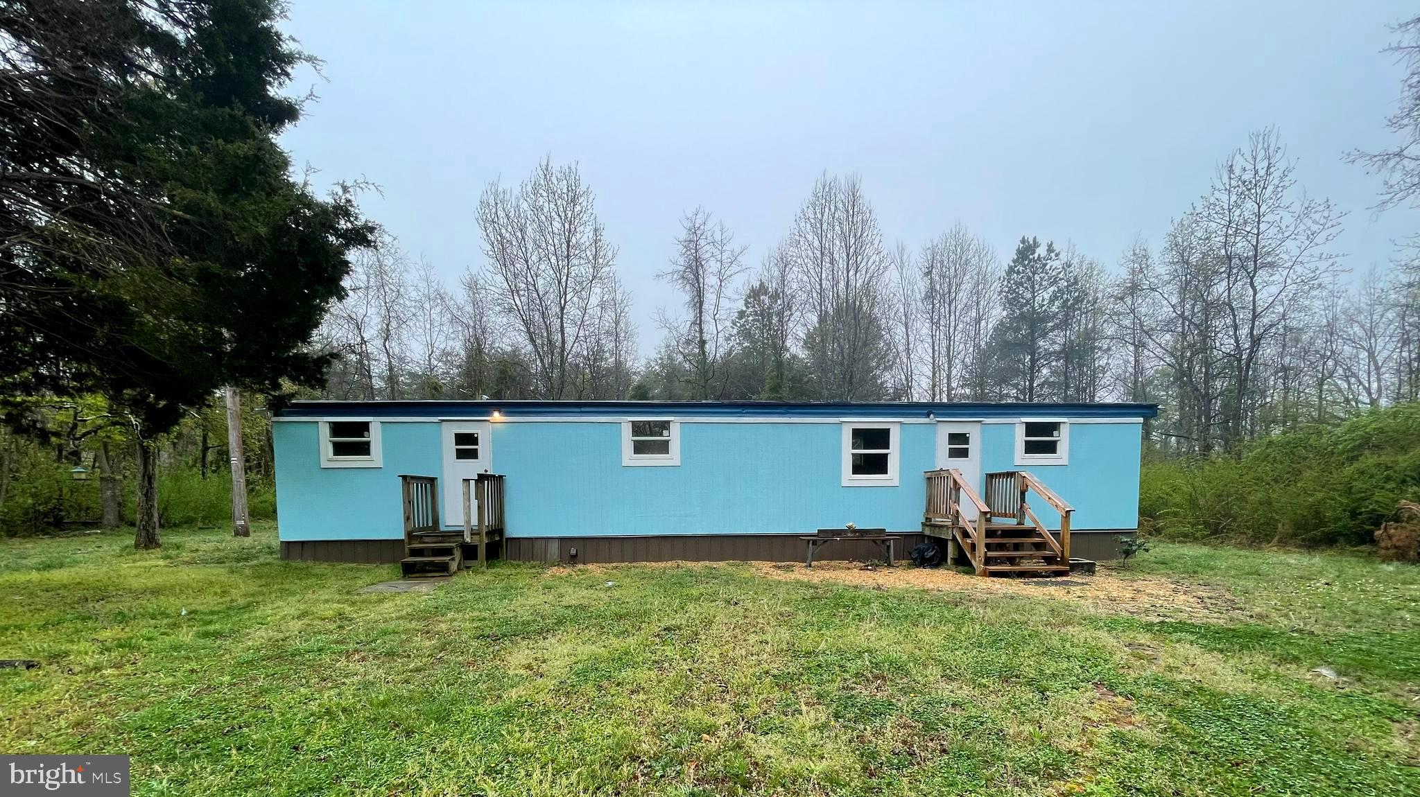 Enjoy peaceful living in this 2 bedroom 1 bath single wide, set on a large and level yard in a quiet country setting. The home features hardwood floors throughout and a simple, functional kitchen ideal for everyday living. With plenty of outdoor space and a calm, open atmosphere, this property offers a comfortable retreat from the hustle and bustle.