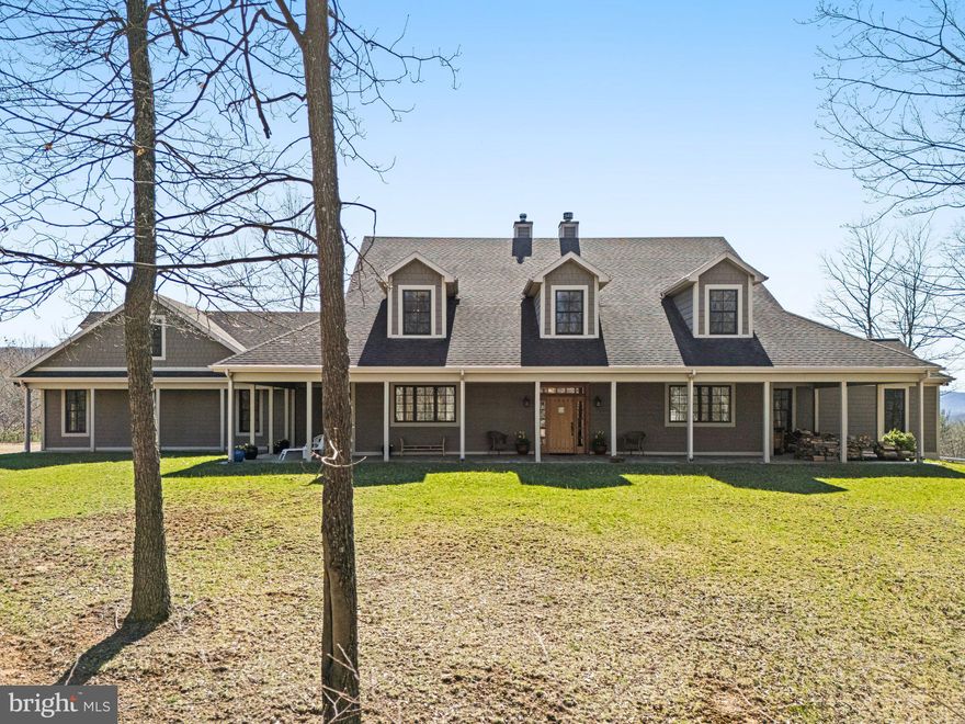 Nestled atop the scenic Polish Mountain, this meticulously maintained 300± acres retreat, just 2 hours from DC/Baltimore, offers unmatched privacy, sweeping vistas, and grand sunset views. Take in the serene landscape from the wrap-around front porch or the expansive back deck that spans the entire rear of the home, providing an idyllic setting to relax and unwind.

Upon entering, you are greeted by an open, airy living space with rich wood floors, high ceilings, and oversized double-pane Pella windows that flood the rooms with natural light. This high efficiency home features SIP panel construction and geothermal heat. 

The kitchen, with sleek countertops and a gas stove, flows seamlessly into the family room and dining area, highlighted by a centrally located wood-burning energy efficient fireplace with brick surround and marble-tile hearth.

A gracious living room, just around the corner, boasts the home's second energy efficient fireplace and provides an elegant space for entertaining guests or enjoying family gatherings.

The first floor is home to two well-appointed bedrooms, each with walk-in closets and private en suite bathrooms — one offering a classic clawfoot tub, the other a spacious standing shower. A convenient first-floor powder room, laundry room, and mudroom next to the attached two-car garage complete this thoughtfully designed main level. An additional two-car garage is accessible from the unfinished basement.

Upstairs, you will find three additional bedrooms, all with walk-in closets. One bedroom enjoys the luxury of an en suite bathroom, while the others share a well-conceived Jack-and-Jill bathroom, ensuring comfort and privacy for all. Large, open rooms complete the second floor, offering a blank slate ready to be tailored to your lifestyle. Whether envisioned as an additional living area, studio, or home office, the possibilities are endless in this versatile upper level.

Outside, a 30’x80’ Morton building and second large workshop offer plenty of space for cars, equipment, and storage while underground power lines offer unobstructed views. The 331± acres property is perfect for hunting, four wheeling, and more. Experience the natural beauty and charm of the region with attractions such as Rocky Gap State Park, the Western Maryland Scenic Railroad, Deep Creek Lake, the Great Allegheny Passage. Enjoy upscale amenities at Rocky Gap Casino, Resort & Golf, all surrounded by a wealth of outdoor activities perfect for all ages

This exquisite property effortlessly blends refined living with the serenity of nature, offering a peaceful retreat that’s both luxurious and family-friendly — an ideal haven for creating lasting memories in one of Western Maryland’s most picturesque settings.