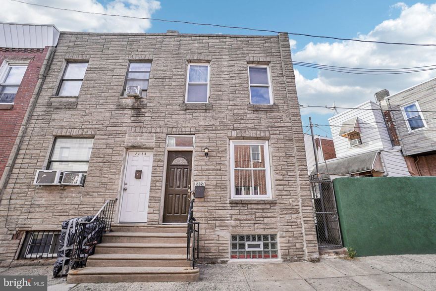 Welcome to this beautifully maintained end-of-row home nestled on a quiet block in the vibrant Lower Moyamensing neighborhood. Just blocks from all that Passyunk Avenue has to offer, this home combines classic charm with modern updates. Enter inside to an open-concept main level featuring original, high-quality hardwood floors that flow seamlessly from the spacious living room into the dining area and kitchen. The kitchen is equipped with stainless steel appliances and opens directly to a private back patio complete with built-in planters — perfect for your urban garden or morning coffee. A convenient half bathroom rounds out the first floor. Upstairs, you'll find three well-appointed bedrooms, including a light-filled front-facing primary bedroom with large windows. The bedrooms share a full hall bathroom. The partially finished basement offers flexible additional living space — ideal for a home office, gym, or media room — and includes laundry with a brand new washer. Other recent improvements include fresh paint throughout, a deep professional clean, a resealed side roof, a renovated and repaired central air system, and a repaired and resealed basement window. This home is ideally located just a few blocks from the restaurants, cafés, and shops of East Passyunk Avenue, with easy access to the BOK Building, Philadelphia sports stadiums, and FDR Park. With its end-of-row status providing extra light and privacy, this move-in-ready home is a must-see. Mortgage savings may be available for buyers of this listing.