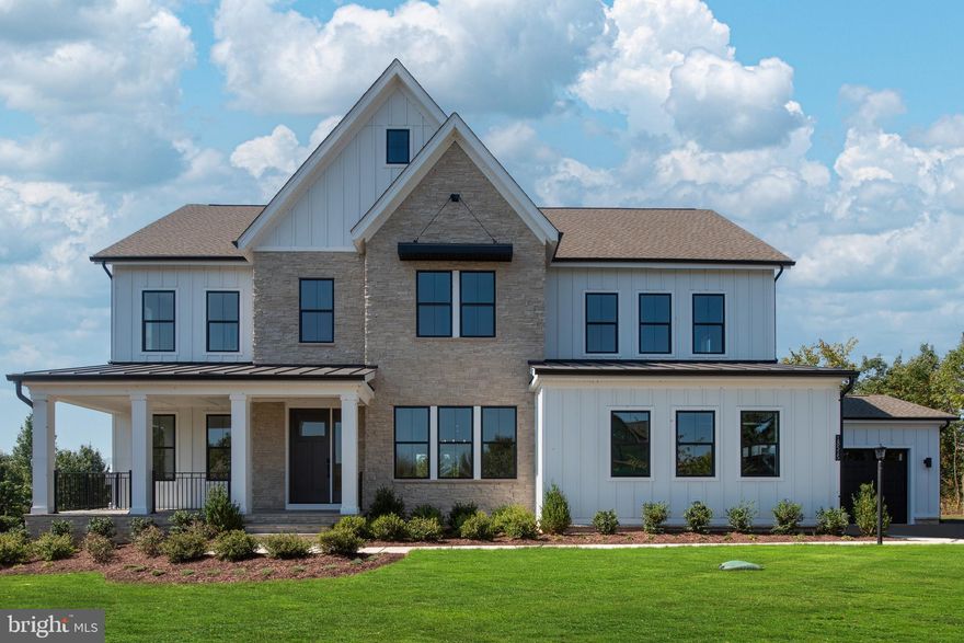 Luxury Living Meets Modern Farmhouse Charm – The Rosslyn at Toll Brothers at Woodburn
Set on a sprawling 4.48-acre homesite, the Rosslyn Modern Farmhouse offers 6,278 square feet of refined living space that effortlessly blends rustic charm with contemporary sophistication. Thoughtfully designed for both comfort and style, this home is a peaceful retreat with generous room for everyday living and exceptional entertaining.
A welcoming foyer opens into a grand, open-concept layout anchored by a spacious great room. The adjacent formal dining room is ideal for hosting, while oversized windows flood the home with natural light and frame picturesque views of the surrounding landscape.
At the heart of the home is a chef-inspired kitchen featuring a large 12’ center island, professional-grade appliances with 2 ovens, a walk-in pantry, and a bright casual dining nook—perfect for morning coffee or intimate meals. The open floor plan creates seamless flow throughout, making it easy to entertain or relax in style.
Expansive 12-foot multi-panel stacking doors from the great room open to a covered patio with a cozy fireplace and retractable screen, extending the living space outdoors. Thoughtfully designed to blend with its natural surroundings, this home’s offers a serene retreat, nestled on a beautiful 4-acre site framed by lush trees and greenery—offering unmatched privacy and a peaceful connection to nature year-round.
Upstairs, the luxurious primary suite is a private sanctuary featuring a tray ceiling, an oversized walk-in closet, and a spa-like bath complete with dual vanities, a soaking tub, and a stunning floor-to-ceiling glass shower. Three additional bedrooms—each with walk-in closets—surround a versatile central loft, offering ample space for family or guests.
On the top 3rd level, a flexible third-floor suite features a walk-in closet and private bath—ideal for a home office, fitness room, creative studio, or private bedroom retreat. This versatile space adapts to meet your lifestyle needs with ease.
The finished lower level completes the home, including a full bath and media room, perfect for movie nights, game days, or weekend entertaining. While the spacious 4-car garage provides plenty of room for vehicles, storage, or workshop space.
Located just minutes from historic downtown Leesburg, residents enjoy easy access to boutique shopping, award-winning dining, wineries, breweries, and year-round entertainment. Major commuter routes are nearby, offering both convenience and connectivity in a peaceful countryside setting. Ready for move-in!
Experience luxury like never before—welcome home to Toll Brothers at Woodburn.