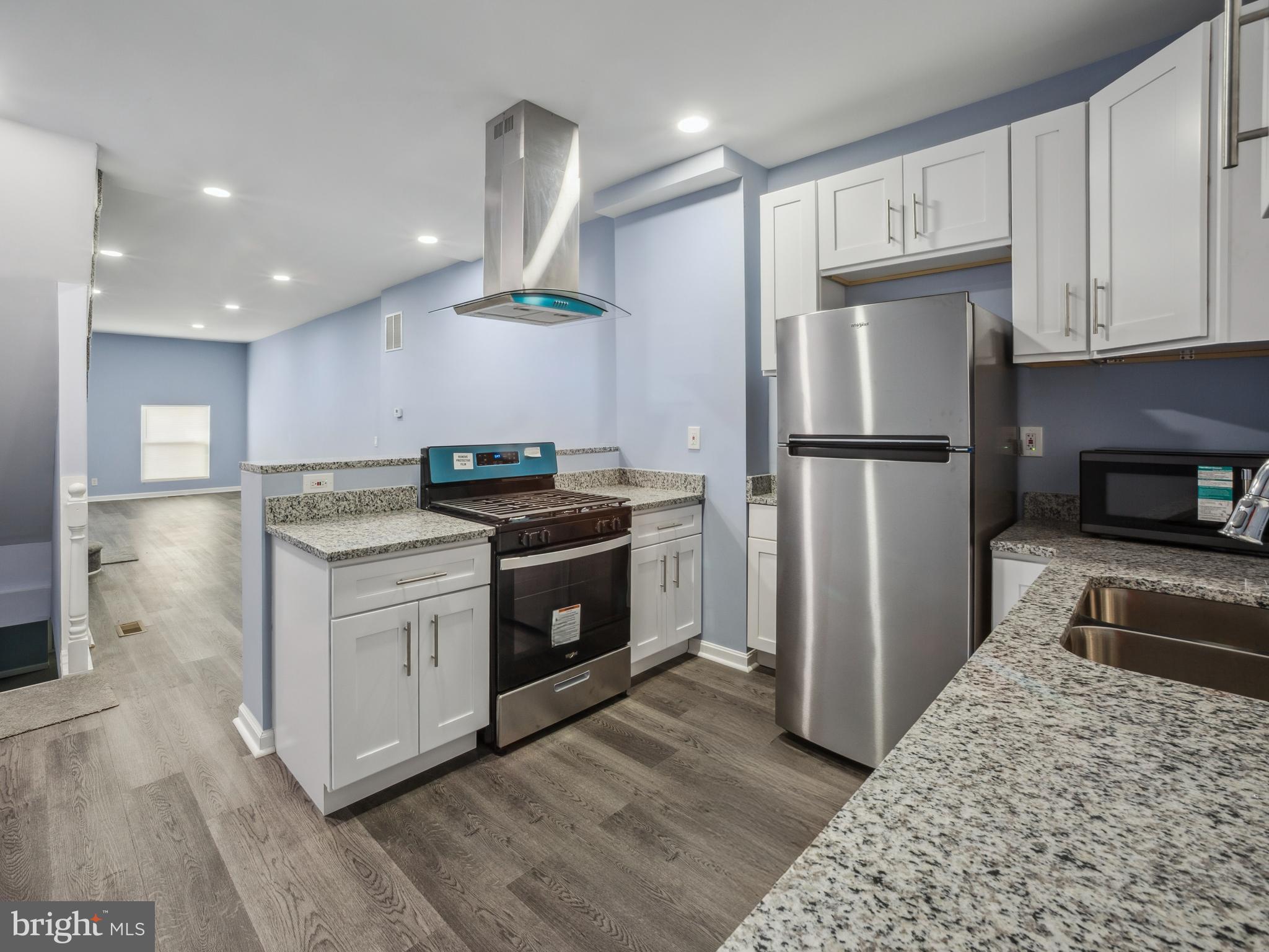 Welcome to 2918 E Monument St, a spacious and inviting home located in the heart of Baltimore. Step inside to discover a modernized kitchen complete with sleek granite countertops, stainless steel appliances, and ample cabinet space—perfect for everyday cooking and entertaining alike. The open floor plan flows seamlessly into the dining and living areas, creating a bright and welcoming atmosphere ideal for gatherings or quiet nights in. Upstairs, you'll find three generously sized bedrooms and a full bathroom. Downstairs, the finished basement offers even more living space, including a **fourth bedroom**—perfect for guests, a home office, or an additional living area. The lower level also includes a washer and dryer for added convenience. Enjoy a cozy backyard space that’s great for relaxing outdoors or hosting weekend get-togethers. Located just minutes from Johns Hopkins Hospital, Patterson Park, and major commuter routes, this property is a fantastic opportunity whether you're looking to settle in or invest. Don’t wait—schedule your showing today and imagine the possibilities!