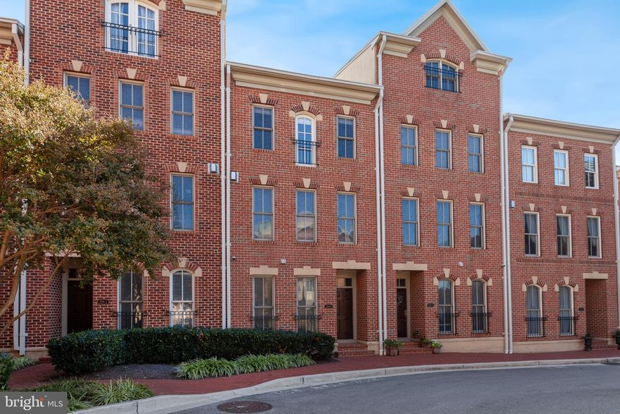 Experience refined city living in this luxury three-level townhome located in the highly sought-after North Shore community of Canton. Perfectly positioned in an ideal, walkable location, this home is just steps from popular restaurants, boutique shops, waterfront promenades, and neighborhood parks.

Inside, you’ll find a thoughtfully designed layout featuring a gourmet kitchen with rich cherry cabinetry, granite countertops,  gas cooking, stainless steel refrigerator, island with breakfast bar and seamlessly opening to an outdoor balcony ideal for morning coffee or evening unwinding. Elegant hardwood floors, 9-foot ceilings, and a cozy gas fireplace with mantle enhance the main living areas with warmth and sophistication.

The spacious primary suite offers a relaxing retreat complete with a large en-suite bath with double sink vanity and soaking garden tub.  An additional fairly sized bedroom and full bath with tub/shower combo completes the upper level. A first-floor bedroom provides flexibility for guests, a home office, playroom, or multigenerational living.

Additional highlights include an all-brick exterior, two-car garage, and two additional driveway parking spaces, offering rare and convenient parking in the city. Set within a water-oriented community, this exceptional townhome blends luxury, comfort, and unbeatable Canton convenience.