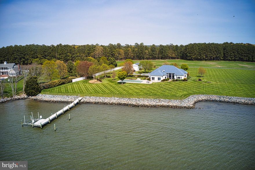STUNNING WESTERLY SETTING WITH AMAZING VIEWS. THIS 3 BEDROOM HOME WITH 12 FOOT CEILINGS IS LIVING ON ONE FLOOR AT ITS BEST. OPEN FLOORPLAN ,HEATED FLOORS IN ALL ROOMS,SLIDING DOORS FROM DINING ROOM AND KITCHEN LEADING TO FABULOUS SCREENED PORCH, OUTDOOR KITCHEN, PATIO AND WALK WAYS TO THE INGOUND POOL AREA. ENDLESS UNOBSTRUCTED VIEWS ACROSS BRIDGE CREEK,THE MOUTH OF BROAD CREEK AND THE CHOPTANK RIVER;  AT NIGHT THE LIGHTS OF TILGHMAN ISLAND IN THE DISTANCE . 
COOKS WILL ENJOY THE GOURMET KITCHEN WITH  STAINLESS STEEL VIKING APPLIANCES , WINE COOLER, WARMING DRAW, FRIDGERATOR/ FREEZER COMBINATION,COMMERCIAL GAS STOVE , HOOD, KITCHEN ISLAND AND  BAR TO HOST A LARGE CROWD.
NAVIEN HEAT ECHANGER AND WATER ON DEMAND, ENCAPSULATED CRAWLSPACE.
THE BONUS ROOM FEATURES  BAR CABINETS W/GRANITE AND ONE DOOR TO ACCESS TO THE OUTDOOR KENNELS  AND ANOTHER ONE TO ACCESS THE POOL WITH AUTOMATIC COVER, THERE IS A COMMERCIAL DOG WASH.
 THE HOME OFFERS A LOT OF STORAGE ,  WALK THRU LAUNDRY/ MULTIPURPOSE ROOM (PANTRY, STORAGE ETC.). THERE IS A METAL BARN BUILDING WITH  OVERSIZED HEIGTH PERFECT FOR BOAT STORAGE,  ADDITIONAL GARAGE , RV OR TRACTOR BARN OR AS A RECRUATIONAL BUILDING. 
THE ROOF OF THAT BARN IS COVERED WITH SOLAR FOR ELECTRIC INDEPENDENCE.
BOATERS WILL ENJOY THE MULTIPLE EASY TO REACH DESTINTIONS LIKE TILGHMAN ISLAND/KNAPPS NARROWS, OXFORD AND FURTHER TRIPS TO CAMBRIDGE.
EASTON AND ST MICHAELS  AND THE OXFORD FERRY ARE A SHORT DRIVE. EASTERN SHORE LIVING AT ITS BEST!