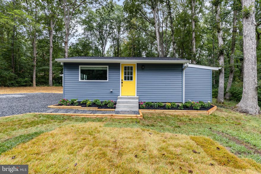 Move-In Ready, Fully Renovated Tiny Home on Private Lot in Hidden Lake Community!  Beach Access!  Completely Rebuilt from the Studs Up! EVERYTHING IS BRAND NEW!  Highlights & Features Include: NEW LVP Flooring Throughout; Center Island Kitchen w/Quartz Countertops, Mission-Style Cabinetry w/Soft-Close Doors & Drawers, Crown Molding, White Subway Tile Backsplash, Open Wood Shelving & Stainless Steel Appliances; Great Room Living Area w/Cathedral Ceiling & LED Recessed Lighting; Pocket Door to  Full Bath w/Ceramic Plank Tile Flooring, Back-Saver Height Vanity w/Quartz Top, Antique Bronze Fixtures, Frameless Glass Door Shower Enclosure w/Floor-to-Ceiling Tile Surround & Ceramic Tile Shower Base & High-Efficiency Toilet; Walk-In Closet w/Custom Organizer. Additional Features: Stackable Whirlpool Washer & Dryer; Carrier Electric Heat Pump w/Programmable Thermostat; 40-Gal Electric Water Heater; Water Treatment System; All NEW Windows, Doors & Siding; NEW Architectural Shingle Roof; NEW Septic System w/Transferrable Maintenance Contract; Large Concrete Patio; NEW Concrete Front Steps & Walkway; Fresh Landscaping w/Seed & Straw; Oversized Shed w/Barn-Style Garage Door; All NEW Gravel Driveway. Enjoy Low-Maintenance Living in a Peaceful Lake Community. Perfect as a Primary Residence, Weekend Getaway, or Investment Opportunity!