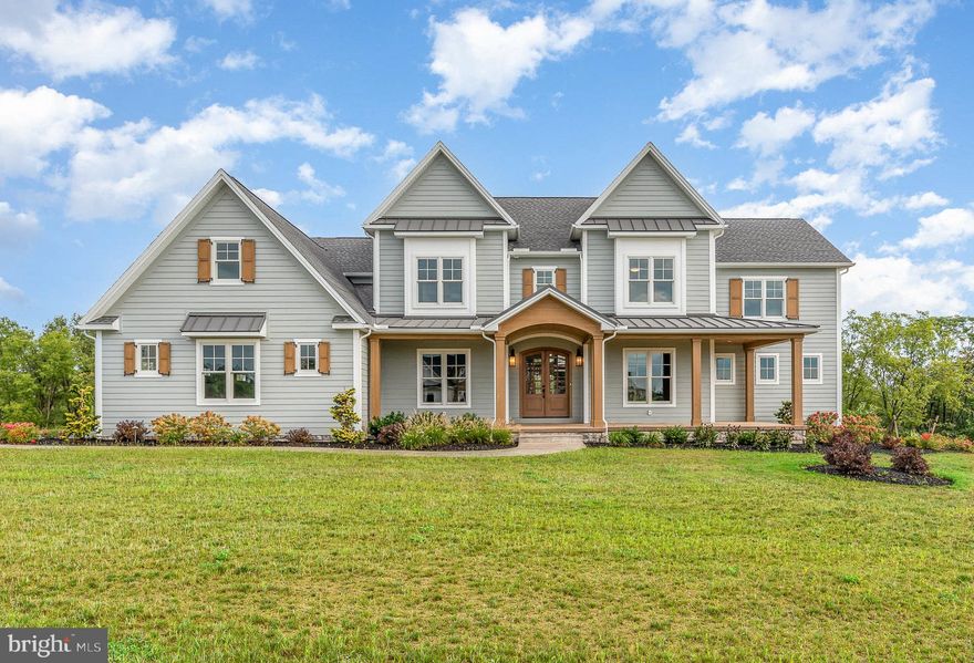 Welcome to Farm Crest in South Hanover Twp.  This Foxbuilt custom home is what dreams are made of. The exceptional craftsmanship, thoughtful attention to detail, unique finishes, and top of the line materials will stand out as you approach the home, even before you enter.  After walking through the foyer, complete with real brick flooring, the home opens to a 2 story ceiling and open concept.  Your eyes will go from 3/4" solid white oak floors, customed stained on site, to a beautiful 2 sided, real brick, gas fireplace that leads to custom beams that are a feature throughout the first floor. Off of the great room is a gourmet kitchen, large island, custom cabinets, and a pantry big enough to live in.  No amenity was overlooked as one of the garage access doors leads into the pantry to make unloading groceries a breeze. The kitchen leads through a solid brick wall mirroring the fireplace to a dual purpose dining and sitting area.  From there you access the large covered deck complete with the other side of the dual sided fireplace. First floor owners suite is just one of two ensuites in the home. It is complete with an electric fireplace, custom bath, and huge walk in closet with it's own laundry. The first floor ensuite also has direct access to the covered deck. The second level has 4 more bedrooms with one of them being the second option of owners suite complete with full bath, custom cabinets, and walk in closet. Two of the remaining three bedrooms share a Jack and Jill bath.  The firth bedroom, another full bath, and bonus room over the 3 car garage complete the second floor.  The walkout basement is on it's way to finishing your dream space with 10 foot superior walls that are insulated and framed ready for electric and drywall.  The basement is also rough plumed for a full bath.  This Foxbuilt home is the epidemy of craftsmanship and design that will make you never want to leave, and excited to come home.  Truly a must see!