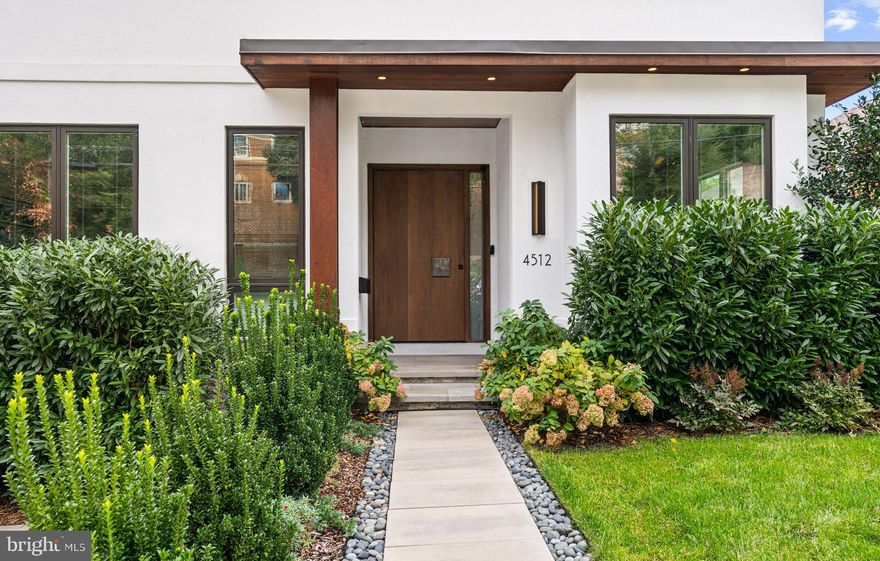 Sited on a beautifully landscaped parcel in DC’s coveted Palisades neighborhood, an exquisitely executed modern masterpiece awaits. Built in 2020, the property presents a sprawling open concept floor plan perfectly appointed for luxurious large-scale living across 4 levels and 7,600 total square feet. This 6 Bedroom, 6.5 Bathroom Contemporary-style residence boasts every amenity, high-end finish, and top-of-the-line fixture imaginable, from an elevator servicing all levels to an EV Charging Station in the 2-Car Attached Garage. Outside, a serene escape seamlessly compliments the interiors, with a pergola covered Courtyard adjacent to the Gourmet Kitchen. On the Top Level, a breathtaking Rooftop Terrace debuts jaw-dropping, south-facing, city and monument views, along with a fully outfitted wet bar just inside. 
<br>
<br>
The charming stone pathway, lined with greenery, leads guests to the covered porch, creating the ideal intimate welcome. The Entry Foyer unveils a gorgeous open layout of the Living and Dining Rooms. The stunning Gourmet Chef’s Kitchen and Family Room follow closely behind with an equally captivating open layout and sleek design. Showcasing a full center island with Dekton countertops, high-end Miele appliances, two dishwashers, and custom Scavolini cabinetry. The Family Room offers ample seating space for large and intimate gatherings alike, in addition to a fireplace and floating shelves. A breathtaking Courtyard, paired with a Pergola, rests between the open layouts. The Main Level is completed by a private Study and a Powder Room.
<br>
<br>
Ascending to the 2nd Level, a spacious, light-filled Recreation Room awaits, flanking three Bedroom Suites. The first of two Primary Bedroom Suites showcases large windows, and a spa-like Full Bath, complete with an air jet tub, dual vanity, modern light fixtures, and walk-in steam shower. Additionally, the Suite features a generous Walk-In Closet with built-in shelves. The two additional Bedrooms each include an en suite Bathroom and Closet. The 2nd Level is complete with a Laundry Room. The 3rd Level reveals an additional Primary Bedroom Suite, boasting sizable windows, terrace access, and a large Walk-In Closet with built-in shelves. The spa-like Bathroom creates the ideal stress-free sanctuary to clear one’s mind, complete with a chic dual vanity, floating sinks, and walk-in shower, leading effortlessly to the soaking tub. The 3rd Floor is completed with a modern Wet Bar, leading to the breathtaking Rooftop. Enjoy a south-facing view of D.C.’s National Monument amidst leafy greenery in this quiet escape from the city.
<br>
<br>
Descending to the Lower Level, the In-Law Suite or possible rental unit awaits, with an independent access. Within lies the open layout of the Living Room, and fully equipped Eat-In Kitchen. 2 additional Bedrooms offer en suite Bathrooms, Closets, and sliding doors leading to the Stone Rear Terrace, Deck and manicured lawn. A Utility Room, Mudroom, Storage Room and spacious Two-Car Garage with EV Charging complete this level.