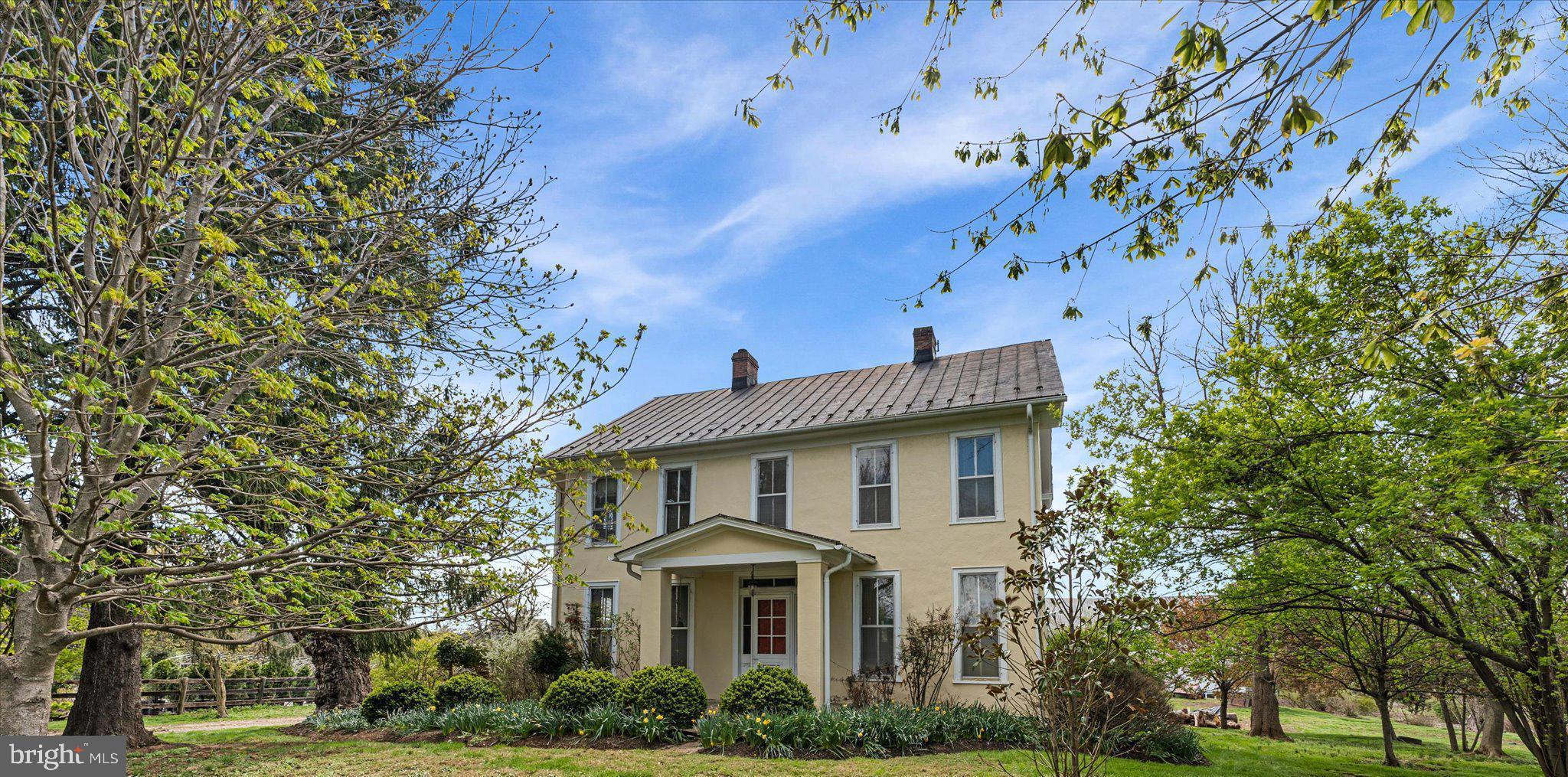 Step Into History and Tranquility – 1890s Farmhouse on 9+ Acres in Loudoun County
Escape the hustle and bustle and rediscover peaceful country living with this enchanting 1890s farmhouse nestled on over 9 acres in scenic Loudoun County. A rare opportunity to own a beautifully preserved piece of history that offers privacy, charm, and incredible versatility—whether you're looking to expand your agricultural ventures or simply enjoy the serenity of open land, all while remaining just minutes from dining, shopping, and commuter routes.
From the moment you enter, you’ll be welcomed by timeless character and thoughtful updates throughout. To your right, a formal living room with soaring ceilings, oversized windows, and a cozy gas fireplace sets a grand yet inviting tone. To the left, an informal sitting room features a wood-burning fireplace and beautifully refinished original hardwood floors—rich with warmth and craftsmanship.
Flowing from the formal living space, the dining room offers built-in china cabinets and leads into a completely renovated kitchen that artfully blends modern convenience with historic charm. Just beyond, discover a sunlit breakfast room with a pass-through window, a butler’s pantry with laundry sink, a renovated full bathroom, and a delightful sunroom for year-round enjoyment. A main-level bedroom offers flexibility as a guest suite or home office.
Upstairs, you’ll find four spacious bedrooms—each with surprisingly generous closet space—and a beautifully updated full bathroom with a walk-in shower. A large laundry room with additional stair access to the kitchen adds convenience, while a full attic provides potential for additional finished space or excellent storage.
Additional highlights include a central vacuum system, three interior-accessible basement spaces ideal for storage or workshops, and multiple heating options: two new heat pumps, an oil/hot water backup system, and an outdoor wood furnace.
Outside, the charm continues with lush native landscaping, raised garden beds, and a variety of agricultural buildings: a barn with 10 tie stalls and 6 pens, two hog pens, six chicken coops (hello, fresh eggs!), a corn crib, and a milk house. With two drilled wells and one spring-fed well, your water supply is abundant and reliable.
This property has previously operated as both a cut flower farm and a successful Airbnb—ready to welcome your vision, whether it's farming, hosting, or simply living your countryside dream. Portions of the land are currently leased by a local nursery, offering built-in passive income. Option to purchase furnished adds even more value.
Don’t miss this chance to own a one-of-a-kind retreat where history, opportunity, and peace converge. Let your imagination run wild—this special property is ready to welcome its next steward.
