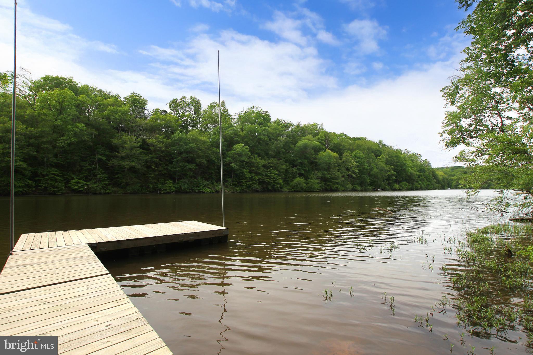 YOU FOUND IT! Your Peaceful RIVERFRONT RETREAT with investment potential. In a shifting luxury market where unique homes are taking longer to attract that special buyer, this one offers something RARE - lifestyle, versatility, and long-term value. Welcome to 10716 Lake Forest Dr, a STUNNING WATERFRONT escape tucked away at the end of a QUIET STREET on the Occoquan River. Whether you’re searching for a serene weekend getaway, an entertainer’s dream, or a smart investment in Northern Virginia’s limited waterfront marketplace - this home delivers it all. Enjoy two EXPANSIVE DECKS, a large stone patio, and a BRAND-NEW 250 sq ft DOCK, perfect for boating, kayaking, fishing, or simply soaking in the serenity. From al fresco dinners to sunset cocktails by the water, the outdoor spaces were designed for both relaxation and play. Inside, the open-concept layout is flooded with natural light and panoramic river views - ideal for entertaining, unwinding, or remote working with a view. This property also presents strong investment potential - use it as a luxury short-term rental, weekend retreat, or long-term asset in a region where waterfront properties remain in high demand and limited supply. This RIVERFRONT GEM stands apart. Come experience what it truly means to live - and invest - where you love.