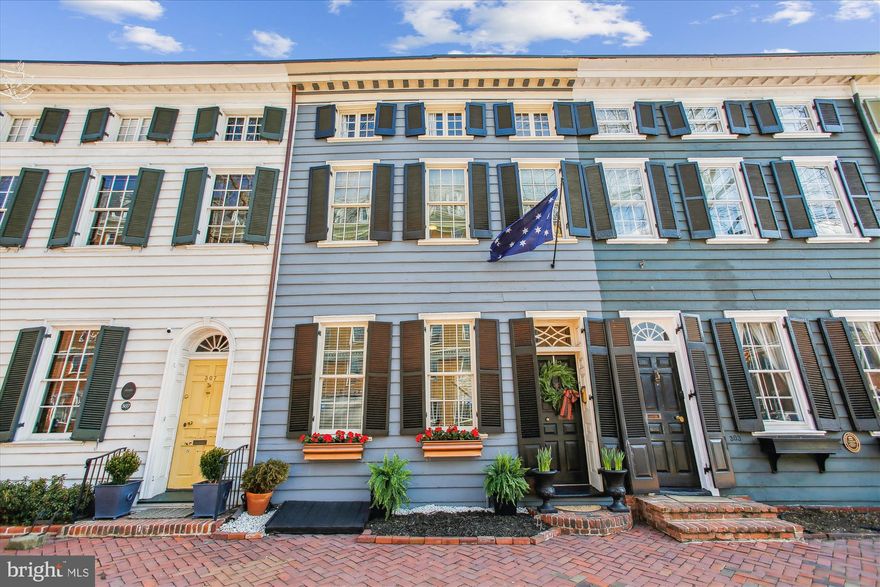 This exquisite 1808 Federal style townhome located in the heart of Old Town Alexandria is ready to go! A picture perfect home with four upper-level bedrooms, 2 full and 1 half renovated baths and surprisingly ample storage,  You can feel the grandness of the home as you enter the foyer.  With gleaming, original heart of pine floors, custom crown moldings and 10’ ceilings this expansive front parlor is adorned with natural light from the front and back of the room. A beautiful, fully functional, wood-burning fireplace makes this an inviting and cozy space. The dining room has a fully functional wood burning fireplace creating an intimate dining experience that can send your imagination back to the early 19th century. This large dining room can accommodate several guests and includes access to the side garden, perfect for al-fresco dining! The lovely kitchen features stainless steel appliances including a new Fisher and Paykel refrigerator. Custom painted floors bring out a feel of smart elegance and sophistication. You will find a door leading to the brick-walled back patio making entertaining from the kitchen so convenient.  Back through the parlor and up a few stairs bring you to a conveniently located half bath that has been tastefully renovated with modern flare. Ascending the stairs to the second level you will come to the first 2 spacious bedrooms. These rooms are filled with natural light. The first bedroom has custom built ins and a fully functional wood burning  fireplace making it a comfortable and versatile space. The second bedroom boasts ample space for modern living. The spacious primary bedroom is its own retreat with expansive closets and large enough for a sitting area. The  en suite, jack and jill bath serves as another masterful design in functionality. On this level you will also find a  conveniently located laundry room. The upper level features an additional elegant, expansive bedroom, a newly remodeled full bath with a claw food tub. Located on a charming block known as “Brockett’s Row”, this historic gem has a designation plaque awarded by the Historic Alexandria Foundation for the preservation and retention of it's architectural integrity. It is located just steps to the shops and restaurants on King Street, a few blocks to the Potomac River and Mt. Vernon Trail, and has easy access to Reagan National Airport, Metro, Amazon HQ2, and major commuter routes. No HOA fees and a long list of meticulous maintenance and modern upgrades makes this an easy choice.