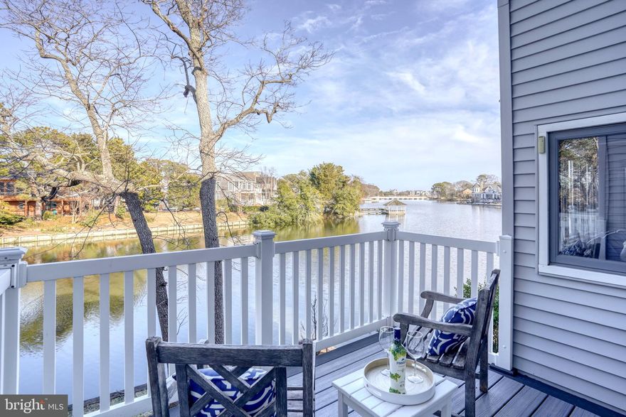 Welcome to Newbold Square, one of Silver Lake’s most secluded waterfront communities — just three easy blocks from the sun, surf, and sand of the Atlantic. Tucked at the end of a quiet dead-end street on Scarborough Avenue Extended, this peaceful setting feels like a hidden retreat, yet everything you love about Rehoboth Beach is right at your fingertips. Just next door, Rehoboth Beach Elementary offers access to basketball, pickleball, and tennis courts — perfect for staying active between beach days.
This desirable end unit offers added privacy and sweeping, unobstructed views of Silver Lake, where mornings begin with shimmering water and evenings end with glowing sunsets. The intimate 40-residence community features a private in-ground pool, a kayak launch for spontaneous paddles, and beautifully maintained grounds that make every arrival feel like a getaway.
The main living space is elevated on the second floor, designed to capture breathtaking lake views. An expansive living and dining area opens onto a spacious waterfront deck — the perfect backdrop for morning coffee, alfresco dinners, or simply soaking in the coastal breeze. A wood-burning fireplace adds warmth and charm for cozy nights year-round. The kitchen, completely renovated in 2022 with stunning quartz countertops, shines with fresh, modern style. The entire unit has been freshly painted, carpets cleaned, and new balcony decking installed, making it truly move-in ready.
Also on the second level, the primary suite provides comfort and convenience with its own private bath and in-unit washer and dryer. Upstairs, a vaulted overlook creates an airy, open feel and leads to a versatile sleeping loft, two additional bedrooms, and a full bath — an ideal layout for hosting family and friends after long beach days.
Silver Lake is home to the beloved Turtle Bridge, where wildlife sightings and peaceful park views are part of your daily routine. Cross the bridge, wander through the park, and follow Stockley Street straight to the iconic Boardwalk. From this prime location, you can stroll to the beach, shops, restaurants, and everything that makes Rehoboth Beach so special.
With its premier waterfront setting, end-unit privacy, thoughtful layout for gathering, and unbeatable proximity to the beach and Boardwalk, this property offers exceptional rental potential — making it not only a beautiful coastal retreat, but a smart investment in the beach lifestyle you’ve been dreaming of.