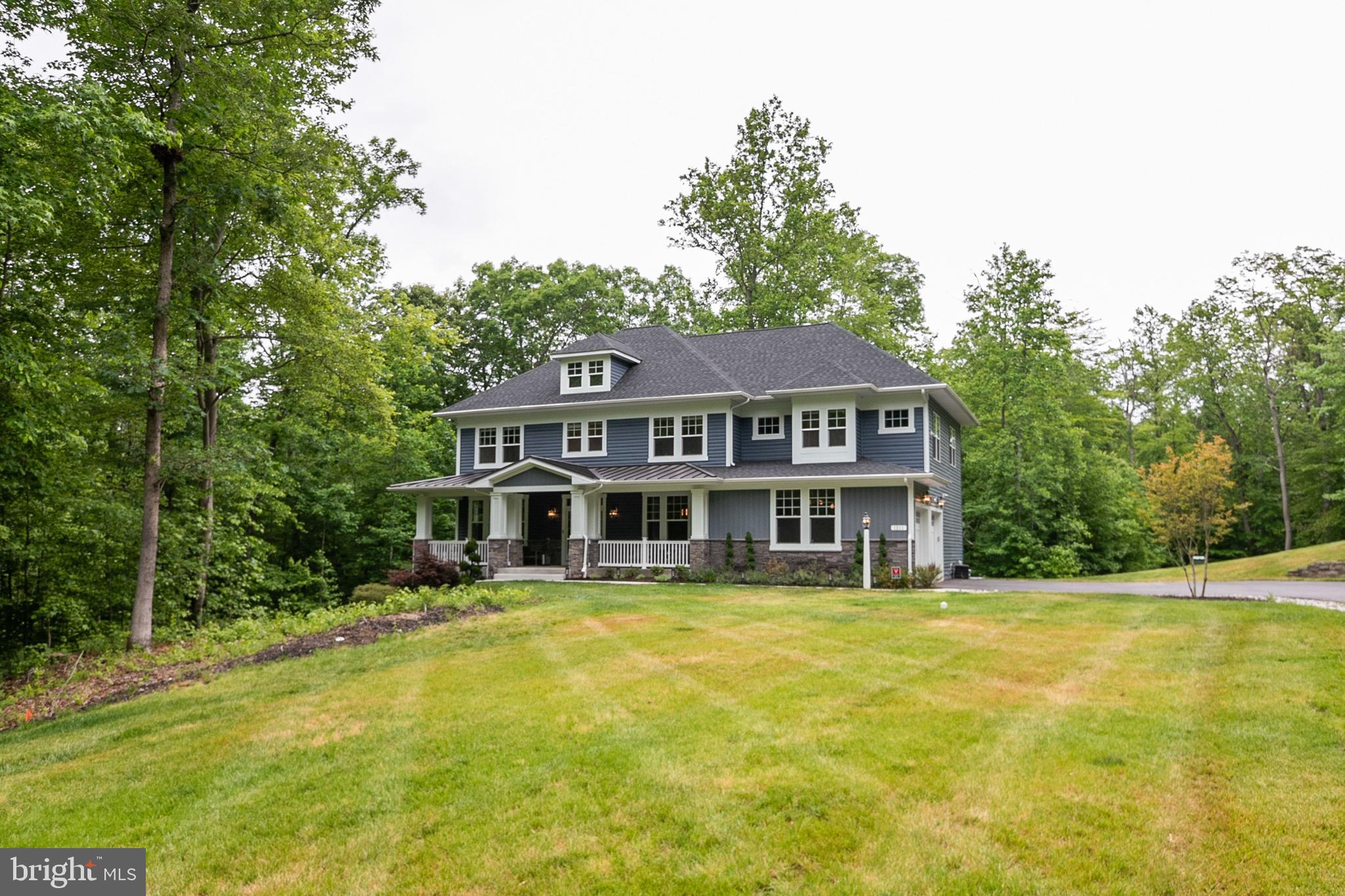 Welcome home! This gorgeous home truly offers it all, from an unbeatable location and high end finishes, to ideal interior design. This home is perfectly situated on over 1.6+ acres of land presenting wooded views in your backyard and beyond, while providing ample outdoor space for recreation and privacy. Enjoy luxurious hardwood flooring throughout and a glamorous kitchen equipped with the finest of details. You'll love the convenience of a first-floor guest bedroom, the stunning fireplace in your living room, and the great natural lighting that seeps in from plentiful windows. This fully decorated masterpiece includes furnishing (available for purchase), a fully decked-out basement, and much more for yours to appreciate when you purchase your new forever home. Escape to your own private oasis in the lovely Woodlands at Plum Creek community, without forgoing easy access to the very best of what Annapolis has to offer in a very short drive!