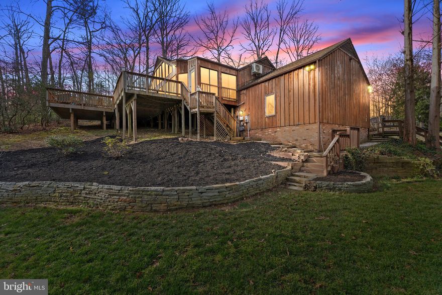 Stunning and truly unique, this half-acre retreat in the highly sought-after Braehead Woods neighborhood offers the rare combination of privacy, nature, and city convenience. Just minutes from downtown Fredericksburg and backing directly to National Park Service land, you’ll enjoy immediate access to trails, paths, and wooded serenity right outside your door.
The updated kitchen features granite countertops and opens seamlessly to the dining and living areas, creating a layout perfect for modern living and entertaining. A standout feature of the home is the expansive fully conditioned 14x35 sunroom, accessed through two sets of sliding glass doors off the main living area. From there, step onto the massive wraparound deck, newly stained and surrounded by mature trees—your own private oasis, all within the city limits.
The fully finished lower level includes a private entrance and full kitchen, making it ideal for an in-law suite, au pair accommodations, or multi-generational living. Recent updates include a brand-new HVAC system, fresh interior paint throughout, new carpet, new luxury vinyl plank and deck staining.
Homes like this—tucked into nature yet moments from downtown—are a rare find.