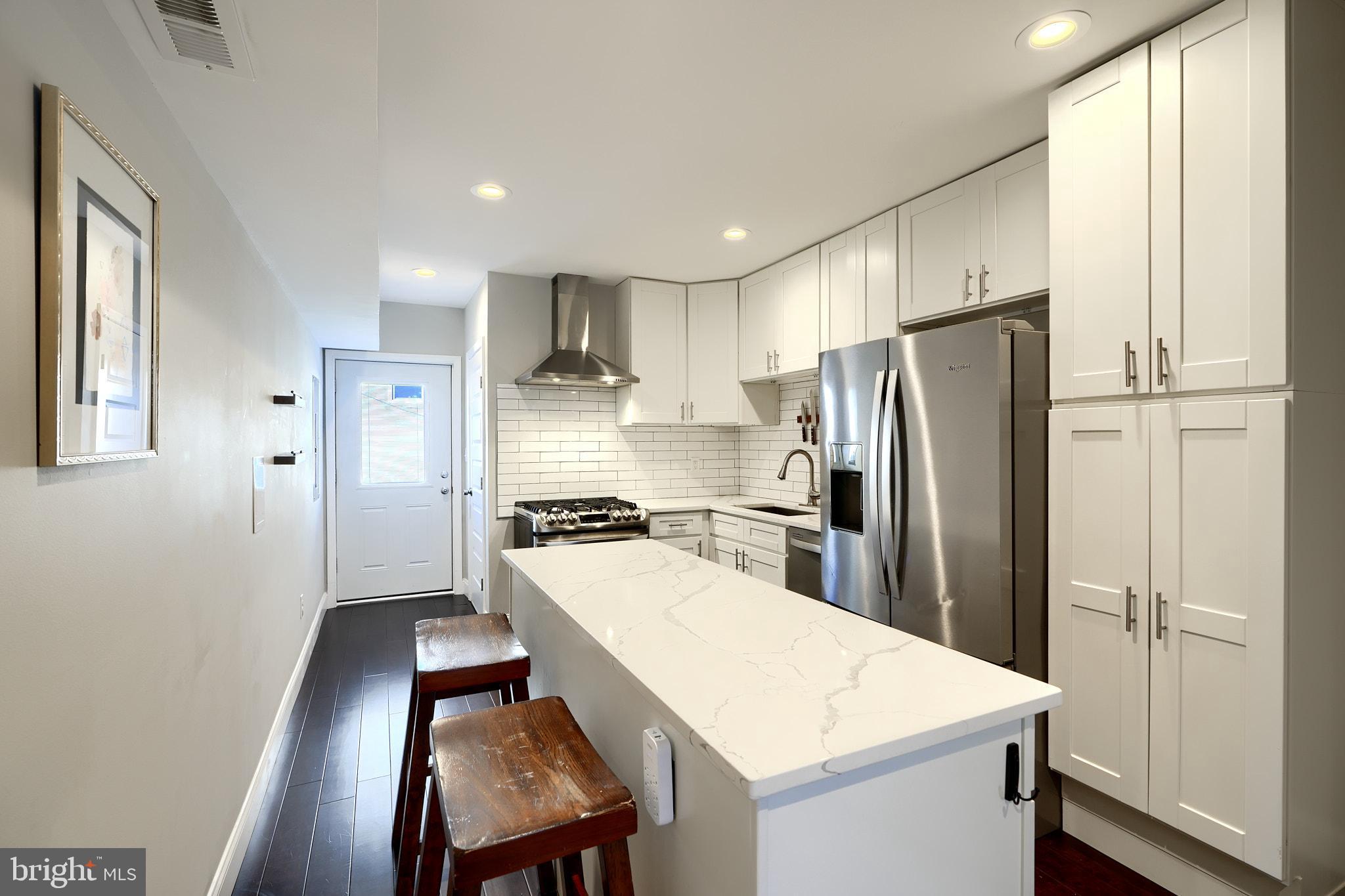 Welcome to 1404 Towson St, a remarkable CHAP renovation that will save you thousands on your taxes! Renovated in 2020, this 3bd/2.5ba home offers an open floor plan, rooftop deck, updated kitchen and tons of storage space. Buyers are greeted with hardwood floors that flow throughout the entirety of the main level. The living room is accented by an original fireplace, exposed brick and historical trim. The open floor plan flows nicely into the kitchen, which is perfect for entertaining guests. Equipped with a dual-fuel convection range, this kitchen will please any home chef! Additional amenities include stainless steel appliances, quartz countertops, a tile backsplash and soft-close cabinets. There's also access to the rear patio, which is perfect for entertaining guests and offers the potential for parking if the utility pole is moved. The main level is completed by the powder room, which is convenient for guests. Upstairs offers a spare bedroom with hardwood floors and a spacious closet, and a guest bathroom in the hallway, which offers a shower/tub combo with subway tile and a nice for storage. Laundry is also available on the upper level for added convenience. The primary suite offers exposed brick, hardwood floors and an ensuite bathroom with stall shower. There is also access to the rooftop deck, which offers panoramic views of Baltimore and a direct shot of Fourth of July fireworks! The home is completed with a finished basement that is great for additional living space or a third bedroom and offers ample storage. If you want to live in the heart of all of the action in Locust Point, look no further than 1404 Towson St!