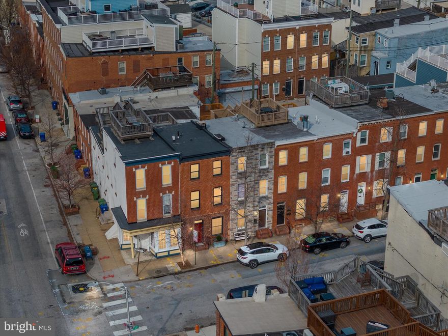 Rarely available 15' wide home on a desirable tree lined block in Riverside/Federal Hill. Unique 4 above ground bedrooms, 2.5 bathrooms, and a bonus 2nd floor living space which could be an office or a playroom. Historically faithful renovation with details such as a restored tin cornice, exposed brick, and 1880 Douglas Fir flooring. Extensive crown molding and detailed baseboard, casing, and chair rail throughout. Eat In Kitchen with soapstone counters, Viking Range, Wolf Ventilation and stainless-steel appliances. Bathrooms are fitted with heated carrera marble bathroom floors and marble topped vanities. Includes a large roof deck, fenced in rear patio, whole house Speakercraft and Bowers & Wilkins (B&W) Sound system. Roof and gutters were fully insulated and replaced with EPDM in 2017. Large, exterior accessed basement for climate-controlled storage.  Additional bonus features include central vacuum system. New washer and dryer, and the water heater was replaced in 2024.