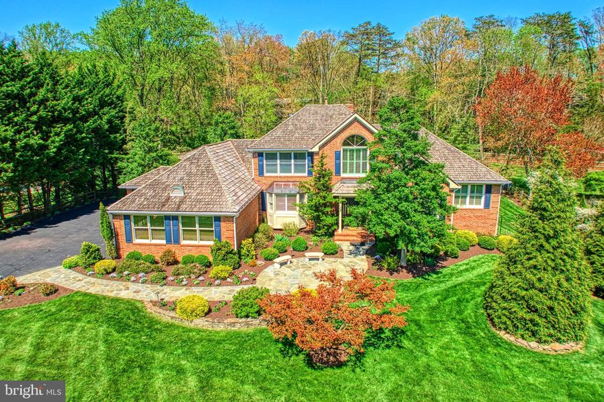 Country Setting - yet so close in!   This luxurious four-sided brick home has it all....a three car side load Garage, a two story Entry Foyer, a main level Primary Suite with it's own Sitting Room and an enormous custom renovated Primary Bath, four Bedrooms and four & one half Baths - over 6,000 sq ft....located on over an acre of land! The updated gourmet Kitchen has been reconfigured with high end appliances, extra cabinetry, marble counters and a convenient Butlers Pantry. In addition to the formal Living and Dining Rooms, there is a main level Office with adjustable built-ins and extra storage, and a double Family Room / Sun Room  -  one with coffered ceilings and the other with wood cathedral ceilings and skylights. These two rooms  are separated and look out on a stately two story gas STONE fireplace.....
The upstairs leads  to three large Bedrooms , two sharing a Jack & Jill Bath and one with its own en-suite. Both Baths have been updated.  
The stunning Lower Level lends itself to all kinds of possibilities.  There is full walkout access with 9 ft ceilings, oversized windows and a third gas fireplace - stone. The Recreation Room is the main focus and is generous and open enough to house both a Sitting Room and a Play Rm - large enough for a pool table. Overlooking this is a fully equipped Wet Bar/Kitchenette with a small fridge and a dishwasher and a recently added Wine Cellar.....perfect for entertaining with room enough for many!
In addition to the Storage Room with built-in shelves, there are three additional rooms that can be used as needed .....perhaps as a 2nd  Office or an Exercise Room with access to the 4th full Bathroom.
This spacious lower level opens out to a breathtaking professionally landscaped rear yard with
a gorgeous custom heated Pool and Spa (resurfaced 2 years ago)........all surrounded by  extensive stone, brick and slate hardscaping & professionally installed custom lighting (both in front & back).
In addition to the Patios , there is a Trex deck off the main Kitchen /Family Room with a built-in cooking station and a custom Veranda overlooking the pool and yard. and a separate wood firepit!
Windows have been replaced, floors have been refinished, Kitchen and Baths have been updated.....Perfect for both the day to day family living and entertaining, this home has been  cared for and exceptionally maintained by the original Owners!   Open Sunday 5/18 1pm to 3pm Watch the videos!