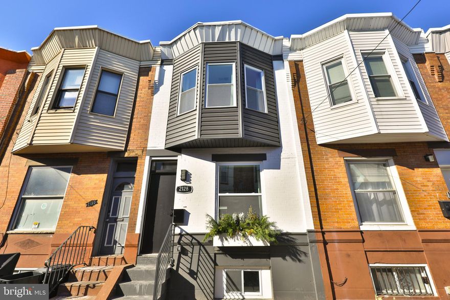 Welcome to this beautifully renovated townhome on a quiet block in the heart of West Passyunk, one of most rapidly appreciating neighborhoods in South Philly. This spacious 3-bedroom, 1.5-bathroom home with back patio and finished basement has been totally renovated from top to bottom so you can move right in and enjoy. As you step inside, you'll be greeted by a light-filled, open-concept living area featuring an exposed brick accent wall, wood floors and recessed lighting. The kitchen boasts white cabinetry, quartz countertops, subway tile backsplash, and stainless steel appliances, including gas range, dishwasher, built-in microwave, and refrigerator. In the back, you will find a patio, perfect for dining al fresco. Upstairs, the three bedrooms are each equipped with ample closets. The primary bedroom at the front of the home, features stunning bay windows that add character and charm. The full bathroom on this level is luxuriously appointed with new fixtures, shower and bathtub combo, and floor-to-ceiling tile. The fully finished basement offers additional living space, perfect for home office, media room, guest room or play area. This level also includes a convenient half bath and laundry area. Additional features of this home include central heat and air conditioning, brand new windows, and all-new systems throughout, ensuring comfort and efficiency. Conveniently located near a variety of restaurants, nightlife, and local favorites such as Stina Pizzeria, Second District Brewing, and Old Original Nick's Roast Beef, this home offers easy access to Center City, major highways, and public transportation. Don't miss the opportunity to make this lovely renovation your new home.