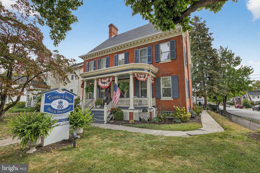 Discover a rare opportunity to own one of Hanover’s most distinguished historic properties. Built in 1905 and listed on the National Register of Historic Places, 252 Frederick Street is an exceptional Victorian-era corner-lot residence/commercial space that blends timeless architectural character with remarkable flexibility. Currently operating as a highly successful bed & breakfast and event venue, the property offers a unique opportunity for buyers seeking a historic residence with an established hospitality presence.

The main residence features 5 bedrooms, 4 full bathrooms, and 1 half bath thoughtfully arranged across multiple levels. The second level includes three spacious bedrooms—each with its own ensuite full bathroom, providing comfort and privacy for guests. The top level offers two additional bedrooms and another full bathroom, creating additional flexible living or guest accommodations. Several bedrooms also feature sitting rooms, while expansive common areas throughout the home provide comfortable gathering and entertaining spaces enhanced by hardwood floors, crown molding, and preserved period architectural details. A secondary staircase—often referred to as a maid’s staircase—connects the main-level kitchen to the upper level, adding both historic charm and functional flow.

At the heart of the home is a chef’s dream kitchen, recently renovated in 2020, featuring beautiful granite countertops, a breakfast bar, pantry, and an oversized island that offers generous prep and serving space—ideal for entertaining or hospitality service.

The home’s exterior spaces further enhance its historic appeal with two welcoming porches on the main level and a balcony on the second level, providing inviting spaces to relax and enjoy the surrounding neighborhood. The main residence also includes a fully accessible fire escape, offering additional convenience for the multi-level layout.

A separate carriage house expands the property’s versatility and charm. The structure retains its original barn doors, preserving its historic character while offering adaptable living space. The second floor of the carriage house was renovated in 2025 and includes three bedrooms, a private living room, full bathroom, and a dedicated makeup area, creating comfortable guest accommodations or extended living quarters. The lower level features a fully functional office space with an additional full bathroom and abundant storage, providing flexible space for administrative, professional, or creative use.

Located in the heart of downtown Hanover, the property is within walking distance of local breweries, shops, restaurants, and community amenities. The location also provides convenient access to regional attractions including Gettysburg National Military Park and Codorus State Park, making it an appealing destination for visitors and residents alike.

With its historic designation, established bed & breakfast presence, renovated kitchen, versatile carriage house, and prime walkable downtown location, this property presents a compelling opportunity to own a truly distinctive legacy property in Hanover Borough.
