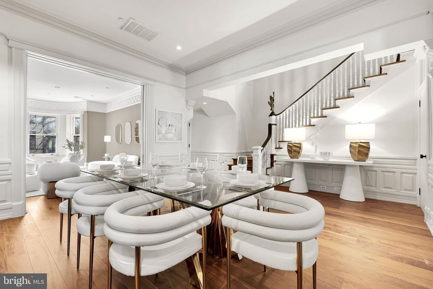 Nestled on a quaint, tree-lined block in Dupont, this extra wide rowhome was reimagined in 2016 with spectacular finishes while maintaining its former charm and character. The gorgeous architectural elements showcase a stunning historic staircase, decorative moldings, multiple fireplaces and oversized sliding pocket doors. The main level flows seamlessly and includes a family room in addition to a living room and a huge dedicated dining room perfect for entertaining. The show stopping chef's kitchen has gas cooking and top-of-the-line appliances including a Thermador range and marble countertops as well as tons of cabinet and storage space. The primary bedroom features a dual vanity bathroom, a decorative fireplace, huge walk-in closet and a sitting area. Private patio and secure 2-car parking included. Just a couple blocks to the Dupont metro, Whole Foods and tons of cafes and dining options and zoned for coveted Reed Elementary School. Building is VA approved.