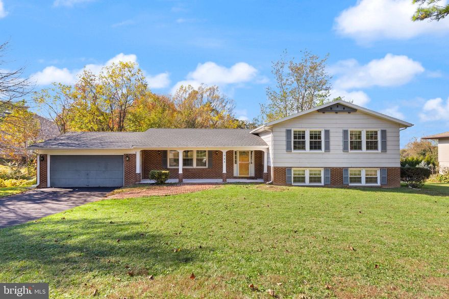 Move-in ready 3BR/2.5BA multi-level home located on a sprawling lot in the quiet neighborhood of Winchester Park.  Drive up to the double wide driveway, park in front of the two-car garage, make your way to the covered front porch and open the door into your new home.  The main floor boasts tons of natural light throughout the large living room, dining room, and eat-in kitchen.  The kitchen features plenty of wood cabinets and counter space, a separate pantry closet, stainless steel and black appliances including a double wall oven and electric cooktop, a deep double stainless sink under a window, and room for a breakfast table.  On the upper floor are two sizable secondary bedrooms, a full bath and a large primary bedroom with a private full bath featuring a walk-in shower.  The first of two lower levels is finished, boasting a wall of brick featuring a wood burning fireplace with a wood mantel in the large family room, a half bath, storage, laundry and a sliding door leading to an amazing yard space.  The lowest level/sub basement is unfinished giving you so many possibilities to create additional living space for your families needs.  From the dining room, step out onto a spacious deck that overlooks the tons of green space and adult trees in the spacious yard.  This home has so much to offer new homeowners and is conveniently located in close proximity to shopping, restaurants, and commuter routes.