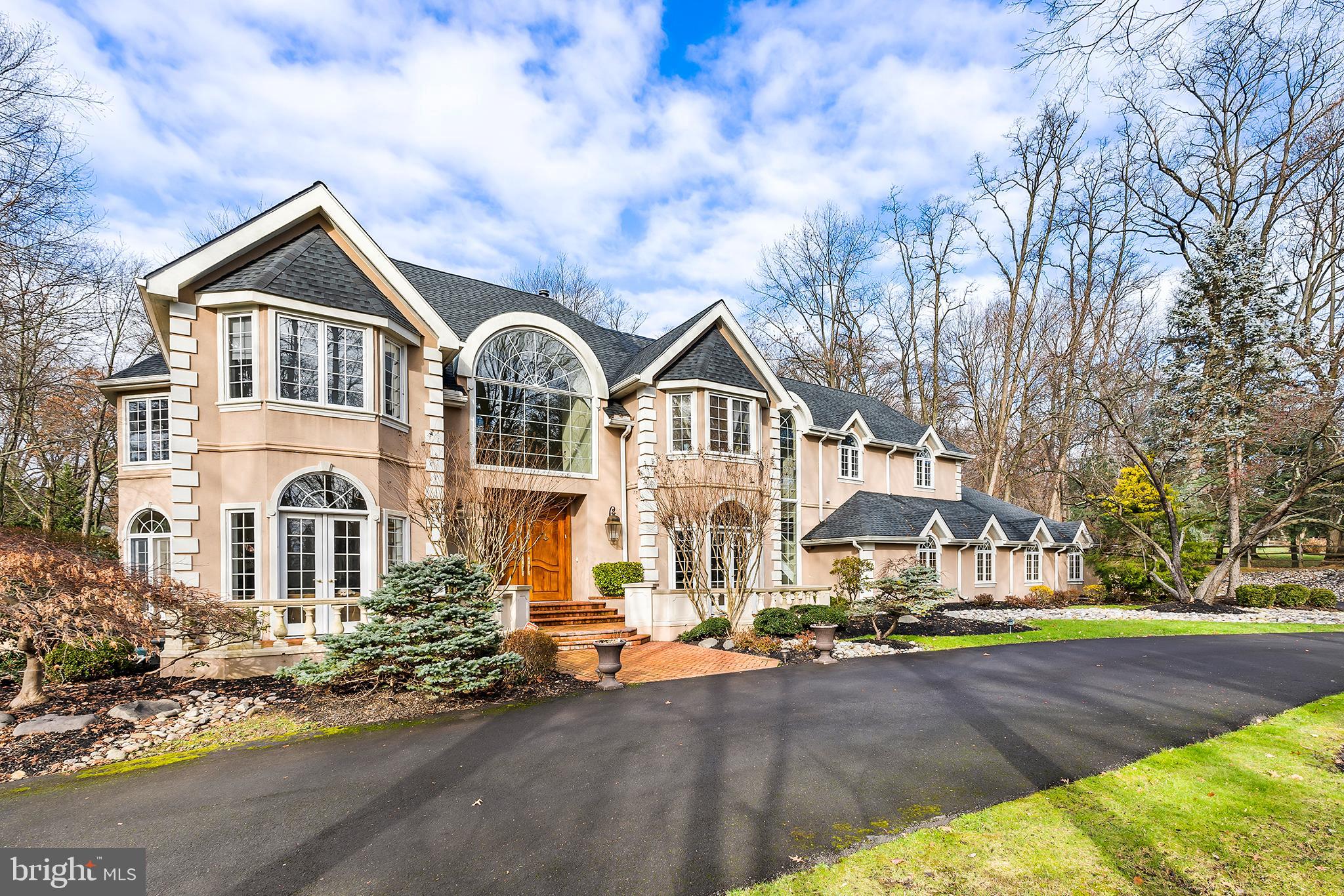 A true piece of art and fresh to the market is this Custom built 8000 Sq ft home in Prestigious Pennock Woods, in Meadowbrook, Pa. From the time you enter this home through the double ornate handmade wood doors, it will take your breath away entering the 2 Story Foyer with a Dual Sweeping stair cases, Elaborate moldings and Marble. If you are looking for a home that has character, individuality and great flow for everyday living and entertaining , you will love this home. The Great Room offers a 2 story setting, with fireplace and a Salon with full wet bar and Floor to ceiling windows looking over the private setting, lush Gardens and Patios. The Gourmet Kitchen offers State of the Art Appliances for any chefs' dream come true, again with an Eating area with Floor to Ceiling windows bringing the outdoors to the inside of the home. Main floor executive private cherry wood finished office space. On the main floor there is a formal living room, formal dining room and salon area with tons of windows and a wet bar. The Presidential Suite (Primary bedroom) in this home offers a fireplace and balconies for your retreats, dressing rooms, dual walk in closets, full Gym with sauna and steam room, plus a glamorous Bathroom with a sunken tub and Oversized Shower. There are 4 additional bedrooms between the 2nd and 3rd floor. The laundry is located on the 2nd floor to make your laundry needs easier to handle. The lower level is finished with a bonus/office/bedroom and a full entertainment area for movies and game night. As you arrive home each day enjoy the large circular driveway and attached over sized 3 car garage. Professionally landscaped with exterior lighting, flowers and gardens, makes this home a true dream to enjoy. Come take a tour of this destiny of a home and know you have arrived to your dream come true.