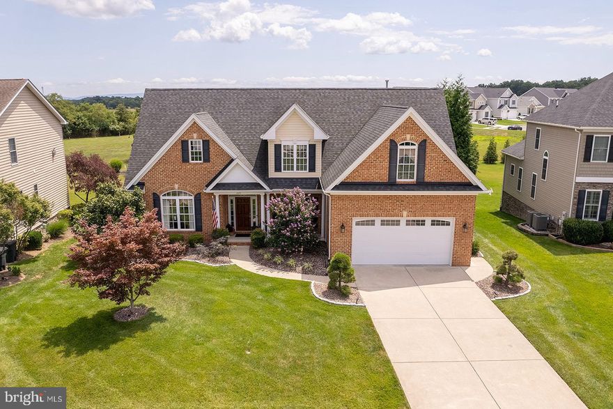 Luxury, Location, and Suburban Privacy!  This house offers it all!  Located in the highly sought after Raven Pointe neighborhood on the east side of the county, you will be close to Rt. 7, I-81, Rt. 522 and Rt.17 for any easy commute to anywhere.  Walk up to the front porch and enjoy the low maintenance landscaping with lighting.  The dramatic vaulted ceilings in the foyer as you enter the house are an eye catcher.  You will see a dining room to the right which has beautiful chair railings, crown moldings, and shadow boxes.  Across the foyer a living room complete with vaulted ceilings and chair railings would make a wonderful place to read.  Vaulted ceilings continue into  the family room with its stone fireplace and open plan to the kitchen.  Cooking in this well appointed kitchen will be a dream.  The kitchen includes a double oven, dishwasher, refrigerator, natural gas stove, and microwave/range hood. With its granite countertops to include a large island, large pantry with custom wood shelving, and solid cherry cabinets, there should be nothing standing in your way of wonderful family meals or great opportunities to entertain.  You can use the sliding glass doors  from the family room to access the large screened in porch.  From there you are a few steps to the concrete patio with built in natural stone fire pit.  Enjoy the privacy of the back yard which abuts historic homestead property to add to your yards privacy.  Back inside enjoy the convenience of a first floor master bedroom suite.  With its large closet and bathroom that includes a tile shower, large soaking tub and granite covered vanity, it is truly an oasis.  The second floor offers 3 more bedrooms, a loft area, and a full bath.  The loft includes built in book shelves and the entire upstairs carpeting has been replaced with luxury vinyl plank. All bedrooms have ceiling fans and generously sized closets.  Head down to the basement for another 1200 square feet of finished space. You will enjoy spreading out in 4 more finished rooms and another full bath.  There are 4 closets and a large unfinished utility room for additional storage.  If you are looking for it, this house has it.  Come see this amazing home today and make it your own before its gone!