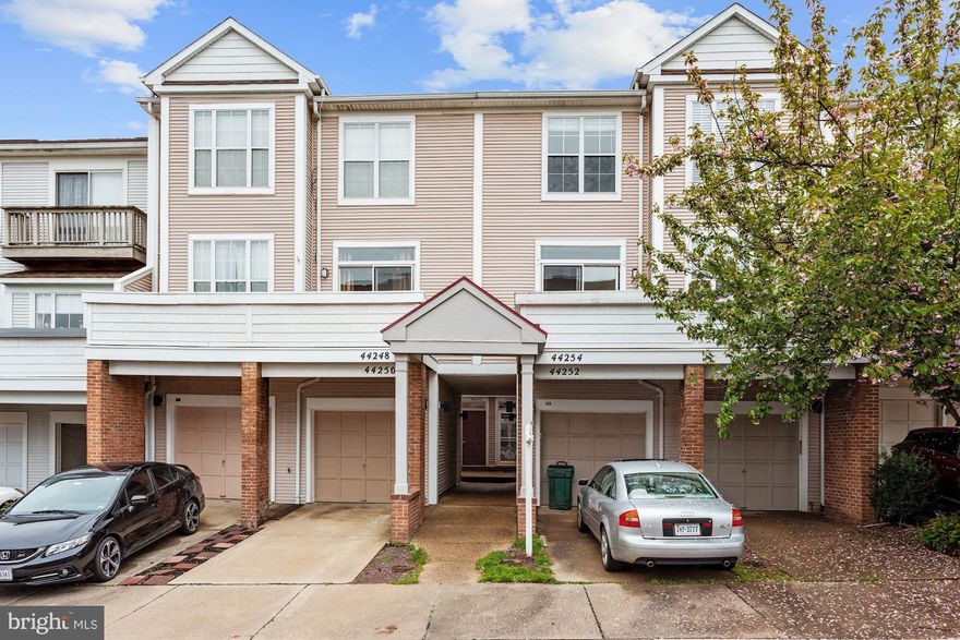 ***** Make sure you check out the 3D Virtual Tour for this house https://my.matterport.com/show/?m=pRjpWJaYN1s ***** Video showings are available via Zoom, Skye, Facetime, Whatsapp, etc. Contact the Listing Agent to schedule a time.*****Location, location, location! Well maintained townhouse located in highly sought-after, beautiful Ashburn Village community. Reserved parking for 2 cars with a private garage and a driveway plus visitor parking available! Ashburn Sports Pavilion, with indoor and pools, gymnasium, basketball, tennis, volleyball, and racquetball courts, steam room and sauna, is within walking distance. Plus 8 private man-made lakes and ponds (including Pavilion Lake), playgrounds, basketball courts, sports fields, party room, fitness center, and several other outdoor pools. Located blocks to shopping and restaurants, schools, bike paths, and so much more! This home is the perfect place to move-to in Metro Accessible Ashburn with Silver line coming soon!Tons of natural light. Big bright windows. Huge sun filled balcony. Gleaming hardwood flooring on main level. Large eat-in kitchen with Stainless Steel Appliances, Built-in microwave, solid surface countertops, and solid wood cabinetry. Separate dining room area off living room. Gas fireplace.  Perfect for Entertaining! Tons of storage in downstairs laundry room and oversized garage. Welcome Home!