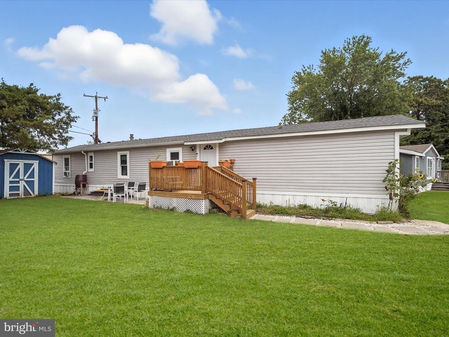 Discover the charm of this beautifully renovated manufactured home nestled in the inviting Patuxent Mobile Estates. This well-maintained turn-key Fleetwood residence blends comfort and functionality with a spacious layout and thoughtful upgrades completed over the past five years. Step onto the welcoming front porch via a custom paver walkway and into a bright interior featuring new laminate plank flooring, as well as all new windows, a replaced roof, updated vinyl siding, and added recessed lighting. The renovated kitchen serves as the heart of the home, boasting white cabinetry, a tile backsplash, an island with pendant lighting, and an adjacent dining area. Centrally located between the living and dining spaces, it creates a seamless flow for everyday living and entertaining. The primary bedroom is privately situated on one side of the home, with a nearby full bath showcasing a tiled tub/shower surround and stylish fixtures. On the opposite end, two additional bedrooms share a second full bath with a sleek standing shower and herringbone tile design. A laundry room and separate storage shed add to the home’s practicality. With a manageable lot size and ample community parking, this home is ideal for those seeking a low-maintenance lifestyle without sacrificing comfort. Residents enjoy access to community amenities, including a boat ramp, playground, and picnic area. These features are perfect for relaxing weekends or spending time outdoors with family and friends. Nestled in southern Anne Arundel County, Lothian offers a peaceful, rural setting with convenient access to major commuter routes like MD-2 and Route 4. Enjoy a quiet lifestyle surrounded by natural beauty, with nearby parks, trails, and waterfront recreation, all just a short drive from shopping, dining, and entertainment in Annapolis, Edgewater, and Prince Frederick.