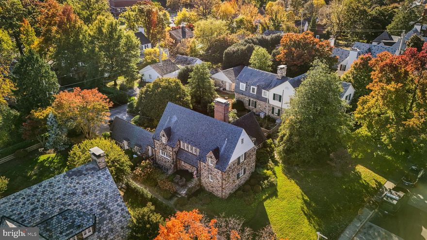 Welcome to 209 Paddington Road, an exquisite stone Cotswold-style home in Homeland designed by the renowned Palmer & Lamdin. This residence seamlessly combines French and English architectural charm with modern sophistication. The grand living room, featuring a soaring cathedral ceiling and stunning fireplace, invites luxurious living. French doors in both the living and dining rooms lead to an expansive stone terrace, perfect for elegant outdoor gatherings. The main-floor suite offers flexibility as a bedroom or den. Upstairs, two en suite bedrooms flank a cozy sitting room with a second fireplace. A fourth bedroom, office, and ample storage complete the third floor. Outside, beautifully landscaped gardens offer serene privacy reminiscent of a classic English village. Meticulously maintained, this home marries timeless character with contemporary comforts for the discerning buyer.