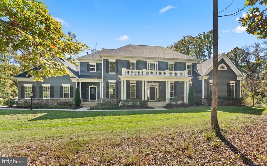 Welcome to your private estate retreat at 80 Shackleford Well Rd—where luxury living meets the serenity of nature on 14.17 breathtaking acres in Stafford County.  A rare gem in this sought-after area, this stately residence offers over 8,300 finished square feet of elegant, thoughtfully designed space.  With 6  bedrooms, 5.5 baths, and room for every need or dream, this home is as versatile as it is stunning. Step inside to a grand, two-story foyer that sets the tone for what’s to come. Soaring 10-foot ceilings on the main level and rich hardwood flooring throughout create a sense of openness and warmth. The gourmet kitchen is a chef’s paradise—granite countertops, a gas cooktop, pot filler, wall ovens, a massive island with breakfast bar seating, and a walk-in pantry.  A separate butler’s pantry and built-in desk area add to the functionality. Whether you're hosting lavish dinners in the formal dining room, cozying up beside the floor-to-ceiling stone fireplace in the family room, or enjoying your morning coffee in the sunroom with French doors leading to a stamped concrete patio, every space is filled with comfort and class. Columns and subtle architectural touches define the open flow between rooms, offering a blend of formality and easy living. The main level also features a private office and a main-level ensuite—perfect for multi-generational living or guests. Upstairs, the primary suite is a true sanctuary: a lighted tray ceiling, a romantic column-framed sitting area, and a his/hers walk-in closet lead to a spa-inspired bathroom with dual vanities, a soaking tub, and a massive two-person shower with dual showerheads and a bench. Bedroom 2 includes a private bath while bedroom 3 & 4 share a Jack-and-Jill setup. Upper level offers convenient access to the laundry room—complete with cabinetry and a utility sink. The walk-up lower level is an entertainers dream that offers endless possibilities: an oversized rec room, a game room, a home theater, a flexible studio or den, and a 6th bedroom with its own full bath. Two storage rooms and 9' ceilings make this lower level feel just as luxurious as the rest of the home.  Beyond the walls, this property truly shines. Watch deer stroll through your yard, pick blackberries, watch your own cherry blossom trees bloom.  Grow your own vegetables in the greenhouse or garden, get some chickens for the coop or explore the land on your own private trails.   Star gazing is amazing here! With room to add stables, a barn, or whatever your vision holds, this is the ideal estate for anyone dreaming of space, freedom, and possibility—without sacrificing convenience. A charming front porch with two entrances (main and mudroom) and a 3-car side-load garage complete the picture. With 3 separate HVAC zones, every inch of this  5 year young home has been crafted with comfort in mind.  Homes like this don't come around often—with this much land in Stafford County. Come experience the lifestyle you’ve been waiting for.   VA assumable loan at 2.375%