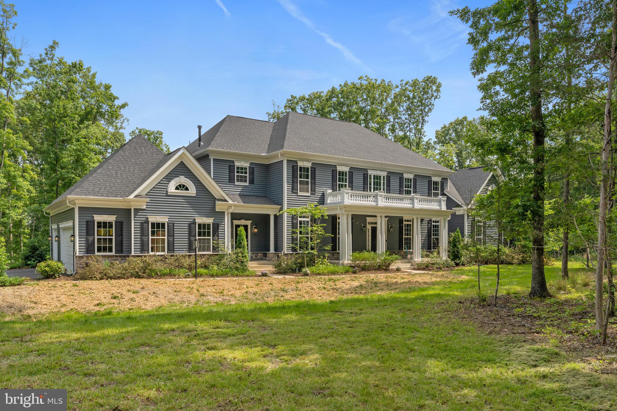 Welcome to your private estate retreat at 80 Shackleford Well Rd—where luxury living meets the serenity of nature on 14.17 breathtaking acres in Stafford County. A rare gem in this sought-after area, this stately residence offers over 8,300 finished square feet of elegant, thoughtfully designed space. With 6 bedrooms, 5.5 baths, and room for every need or dream, this home is as versatile as it is stunning. Step inside to a grand, two-story foyer that sets the tone for what’s to come. Soaring 10-foot ceilings on the main level and rich hardwood flooring throughout create a sense of openness and warmth. The gourmet kitchen is a chef’s paradise—granite countertops, a gas cooktop, pot filler, wall ovens, a massive island with breakfast bar seating, and a walk-in pantry. A separate butler’s pantry and built-in desk area add to the functionality. Whether you're hosting lavish dinners in the formal dining room, cozying up beside the floor-to-ceiling stone fireplace in the family room, or enjoying your morning coffee in the sunroom with French doors leading to a stamped concrete patio, every space is filled with comfort and class. Columns and subtle architectural touches define the open flow between rooms, offering a blend of formality and easy living. The main level also features a private office and a main-level ensuite—perfect for multi-generational living or guests. Upstairs, the primary suite is a true sanctuary: a lighted tray ceiling, a romantic column-framed sitting area, and a his/hers walk-in closet lead to a spa-inspired bathroom with dual vanities, a soaking tub, and a massive two-person shower with dual showerheads and a bench. Bedroom 2 includes a private bath while bedroom 3 & 4 share a Jack-and-Jill setup. Upper level offers convenient access to the laundry room—complete with cabinetry and a utility sink. The walk-up lower level is an entertainers dream that offers endless possibilities: an oversized rec room, a game room, a home theater, a flexible studio or den, and a 6th bedroom with its own full bath. Two storage rooms and 9' ceilings make this lower level feel just as luxurious as the rest of the home. Beyond the walls, this property truly shines. Watch deer stroll through your yard, pick blackberries, watch your own cherry blossom trees bloom. Grow your own vegetables in the greenhouse or garden, get some chickens for the coop or explore the land on your own private trails. Star gazing is amazing here! With room to add stables, a barn, or whatever your vision holds, this is the ideal estate for anyone dreaming of space, freedom, and possibility—without sacrificing convenience. A charming front porch with two entrances (main and mudroom) and a 3-car side-load garage complete the picture. With 3 separate HVAC zones, every inch of this 5 year young home has been crafted with comfort in mind. Homes like this don't come around often—with this much land in Stafford County. Come experience the lifestyle you’ve been waiting for. VA assumable loan at 2.375%