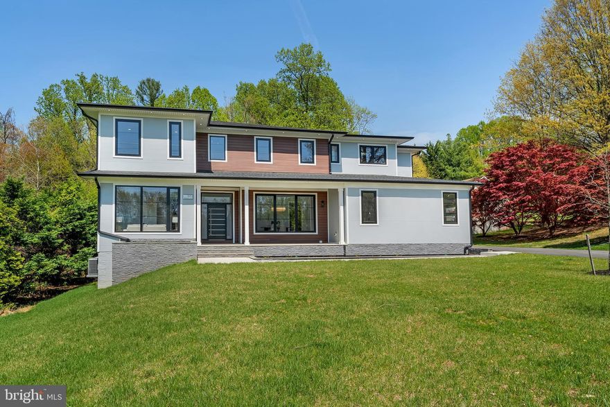 NBC News filmed a news story on the special features! This newly constructed 8,000-square-foot custom home offers solid craftsmanship and carefully selected imported materials throughout. Situated by Great Falls Woods with an access drive to & from Preserve Court, the property delivers a well-designed floor plan with generous space and practical features. 
The seller built this home as a personal residence. It features extras that are not common in other new homes such as: foam insulation in walls and attic, hardi-siding and cladding on the exterior, custom imported European doors and window (energy and sound efficient), solid core interior doors, full stone slab tile, heated floors, surround sound wiring throughout, separate media room, and a  safe room with concrete finished walls and ceiling and steel door as featured in NBC news!
The main and upper levels feature hickory hardwood flooring and an architectural floating double staircase. The kitchen includes Cambria countertops, a large center island, Bosch stainless steel appliances, induction cooktop, and a walk-in pantry with custom shelving. Nearby, the sunroom dining area overlooks the backyard, and the family room includes a 5-foot linear pellet fireplace with built-in shelving. The main level also features a formal dining room, a family library with custom built-ins, a separate sitting room/office , a butler’s pantry with stone countertops and high end cabinets, and a spacious mudroom that could be converted into a second kitchen. A powder room with full-height imported full slab stone tile adds a unique touch.
Upstairs, five bedrooms each have access to luxury bathrooms with custom tile, designer vanities and Hansgrohe fixtures. The primary suite includes two walk-in closets with California Closets systems, a built-in vanity area, and walk in the clouds custom tiled bathroom with a freestanding jetted tub, glass-enclosed shower with lighting and extra jets, and a private rear balcony overlooking the backyard.
The walkout lower level includes a large recreation room, wet bar, a second laundry area, a pre-wired theater room, a fifth full bathroom, and a finished secure safe room. Smart home wiring is already in place.
Outdoor features include a front patio, a maintenance-free rear deck, and a lower-level patio. The 0.75 acre lot has room for a private future pool. The attached 3-car garage includes 2- EV charging. This is an amazing opportunity for buyers seeking a spacious, newly built home in Great Falls with quality materials and a versatile layout. The home is within walking distance from the rear to CVS & Seneca Shopping Plaza which features several great dining options. It is close to Herndon Metro,  Great Falls Village , Reston Town Center,  Great Falls Park & Dulles Airport!